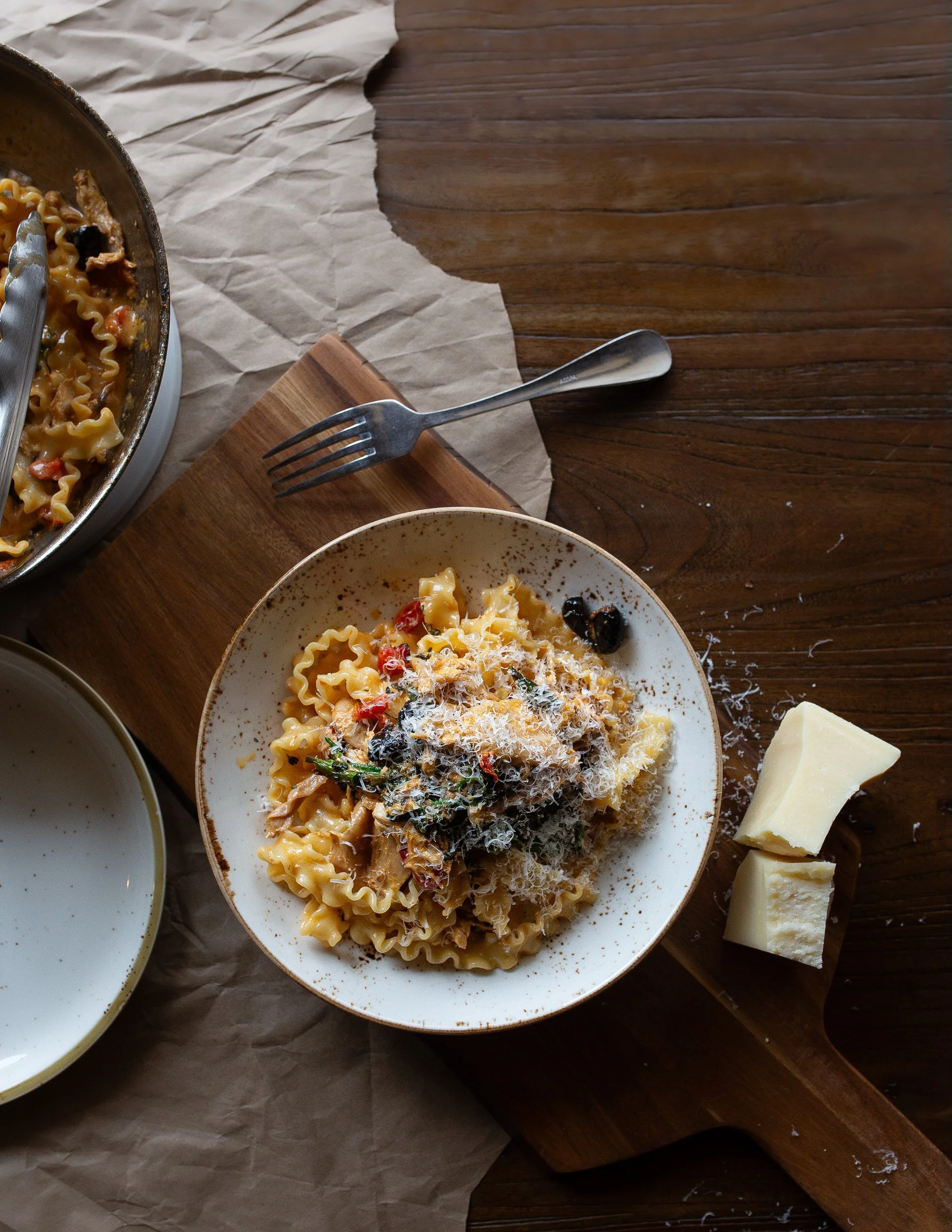 A plate of pasta sitting on a wooden table 