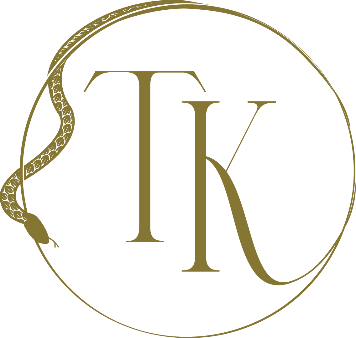 A black circular logo with a gold snake coiled around the left side, and gold letters 'T' and 'K' in the center.