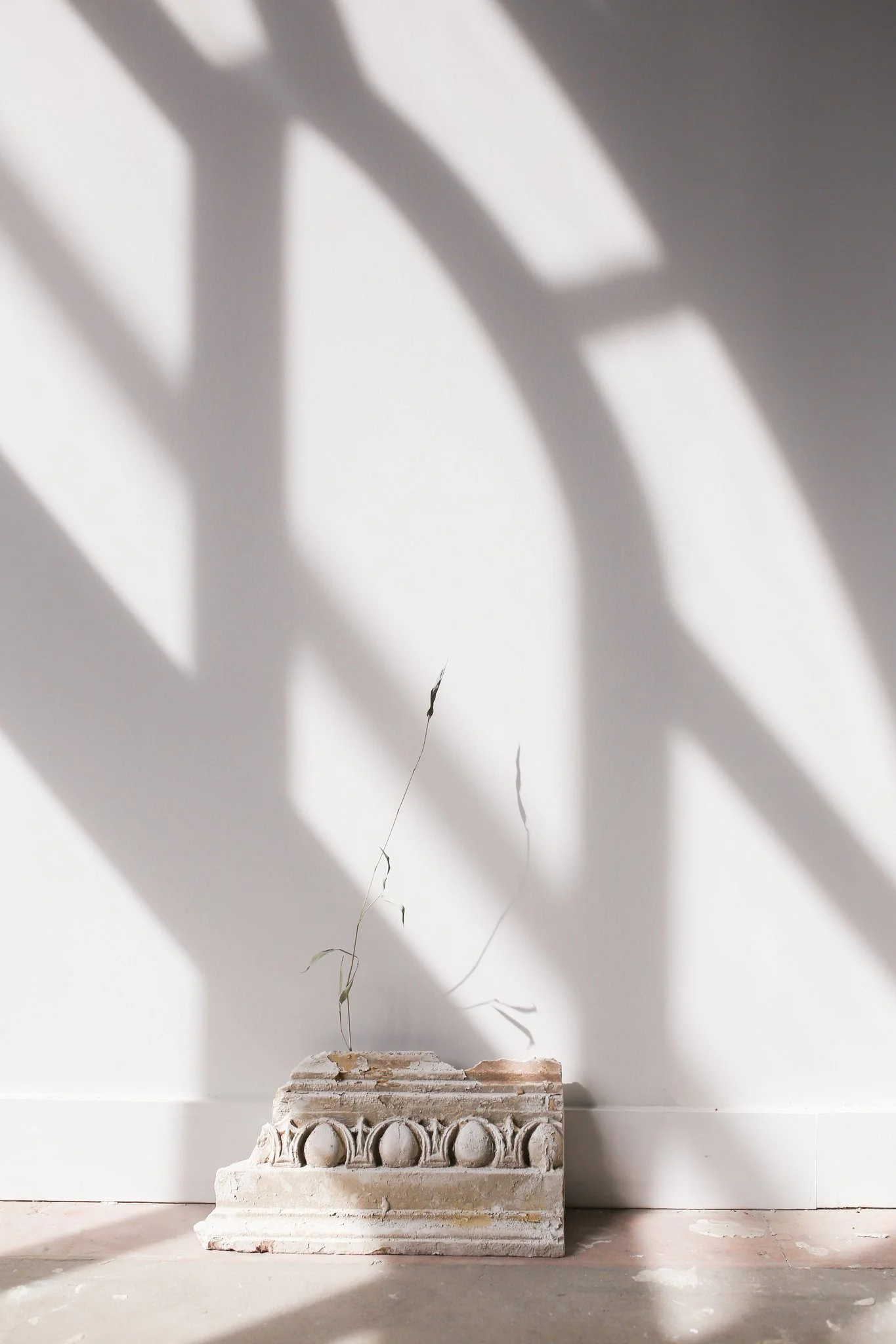 A small sculpture sitting in front of a white wall 