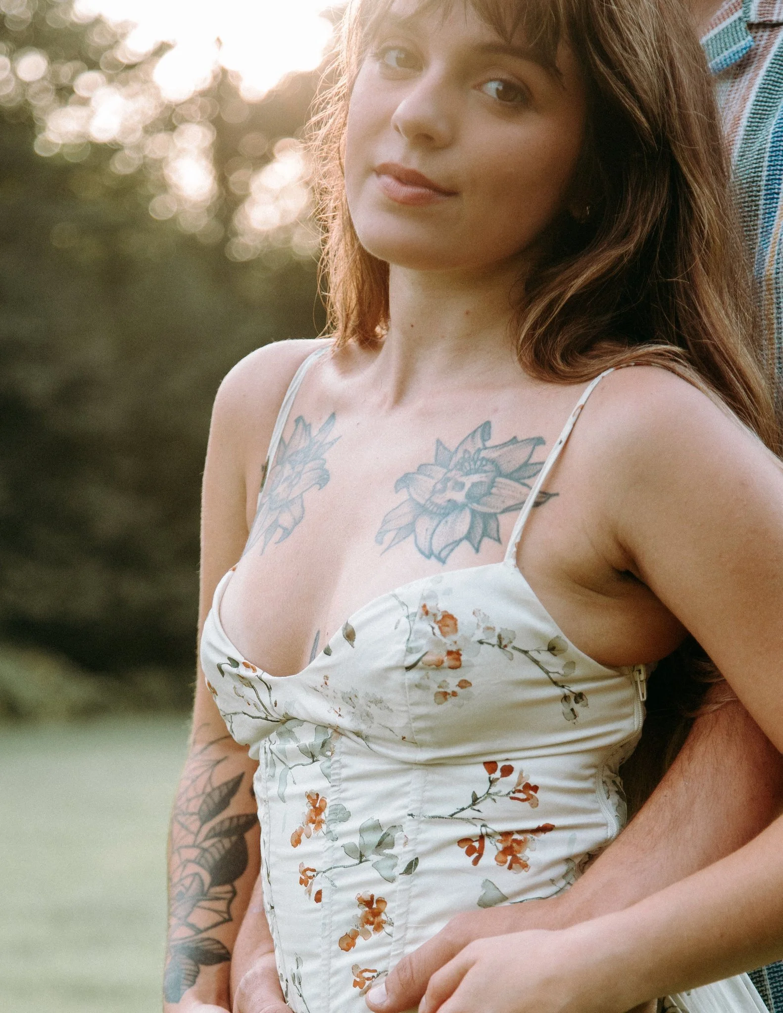 A person standing behind their partner with their arms wrapped around them