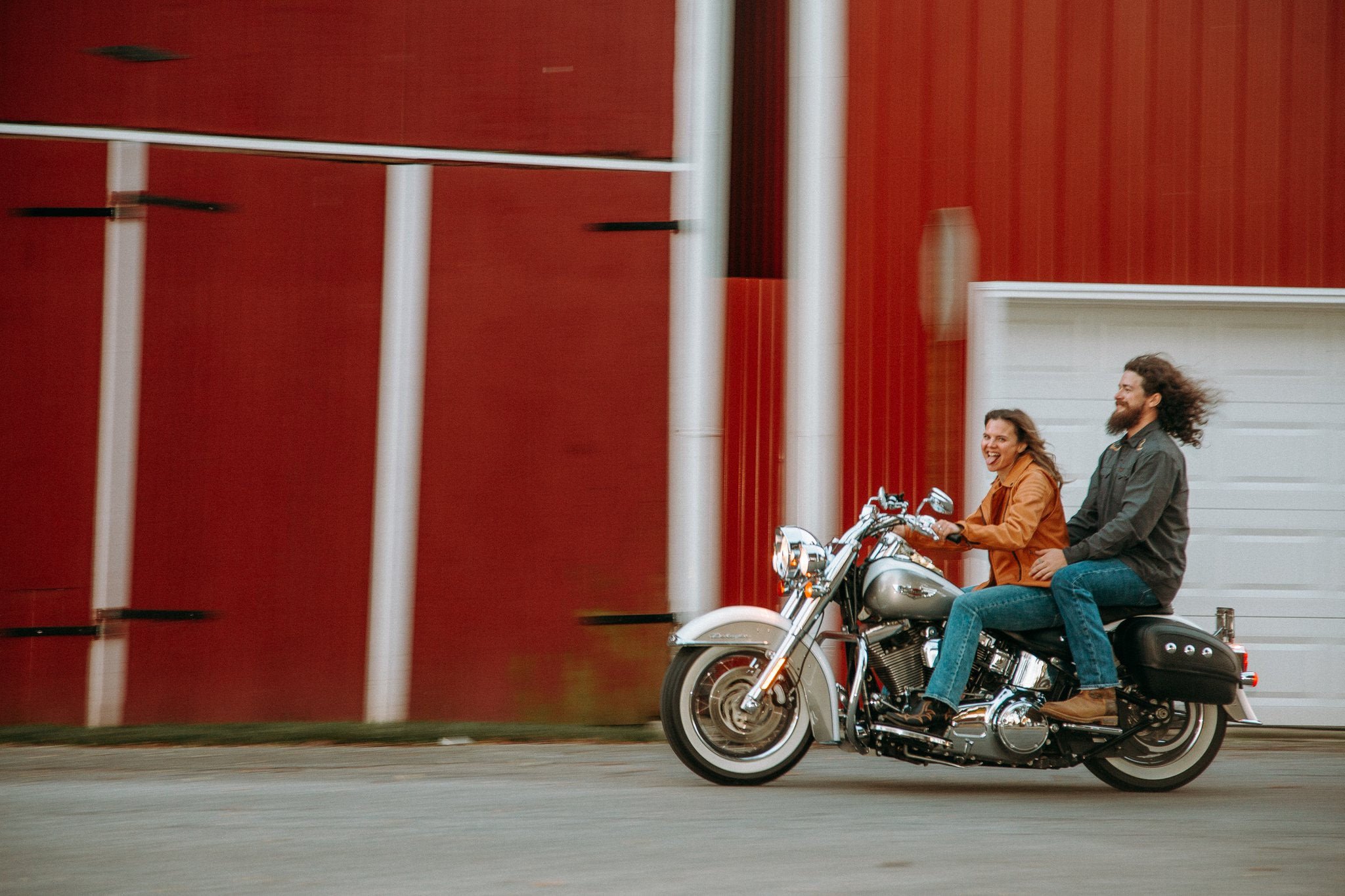 A couple riding a motorcycle together 