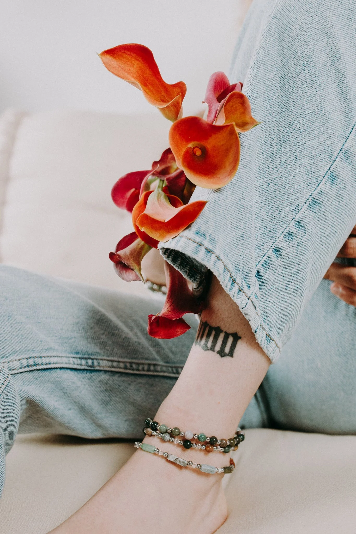 a close up of someone's ankle showing off anklets