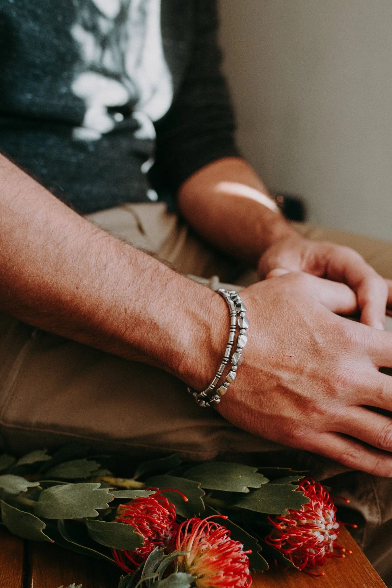 A close up of a bracelet on someone's wrist 