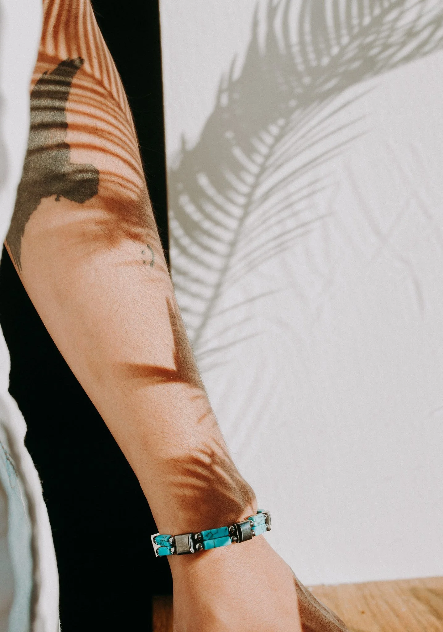 A close up of a bright bracelet on someone's wrist 