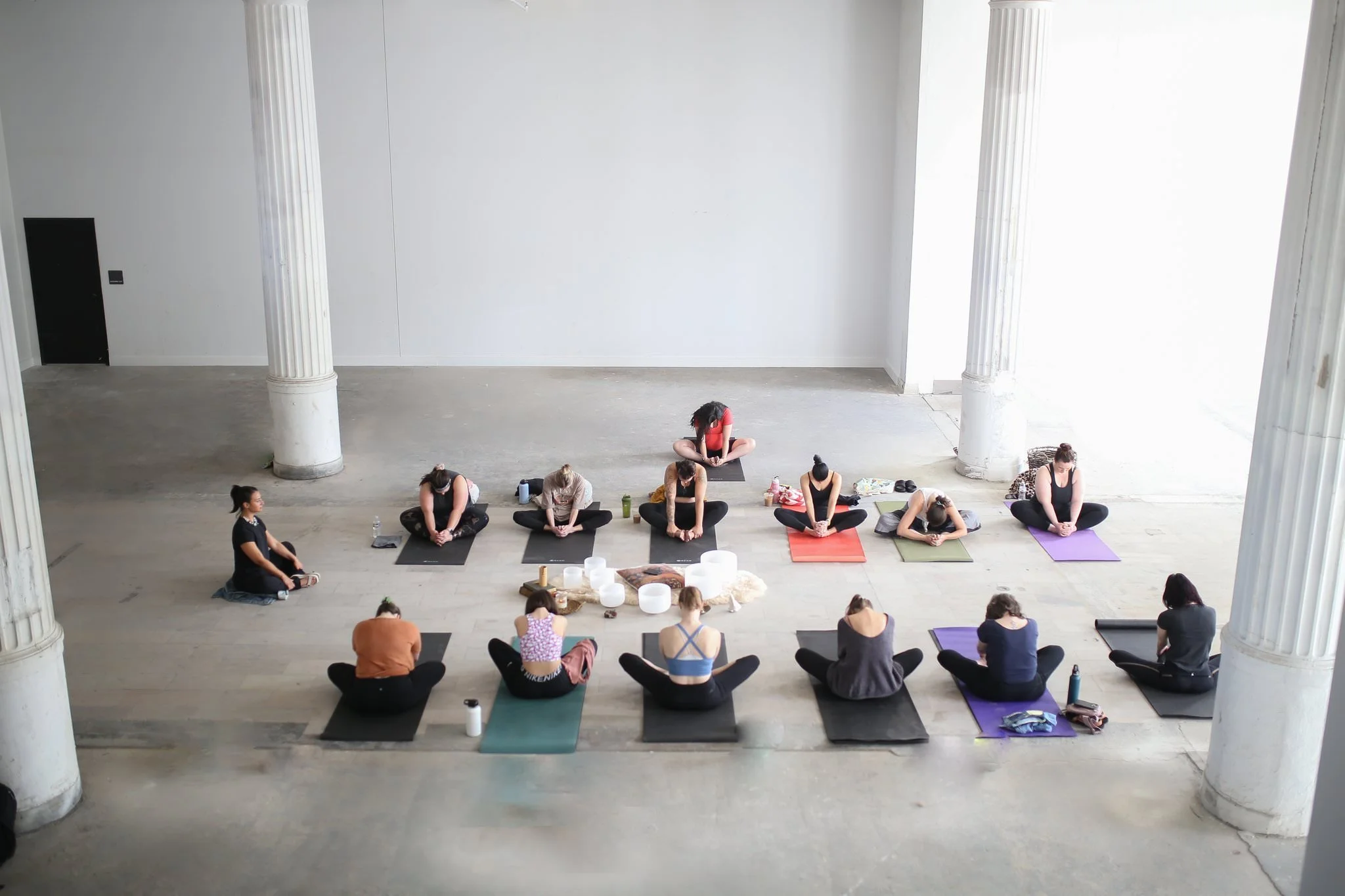 View from above of a yoga class in a large, open space