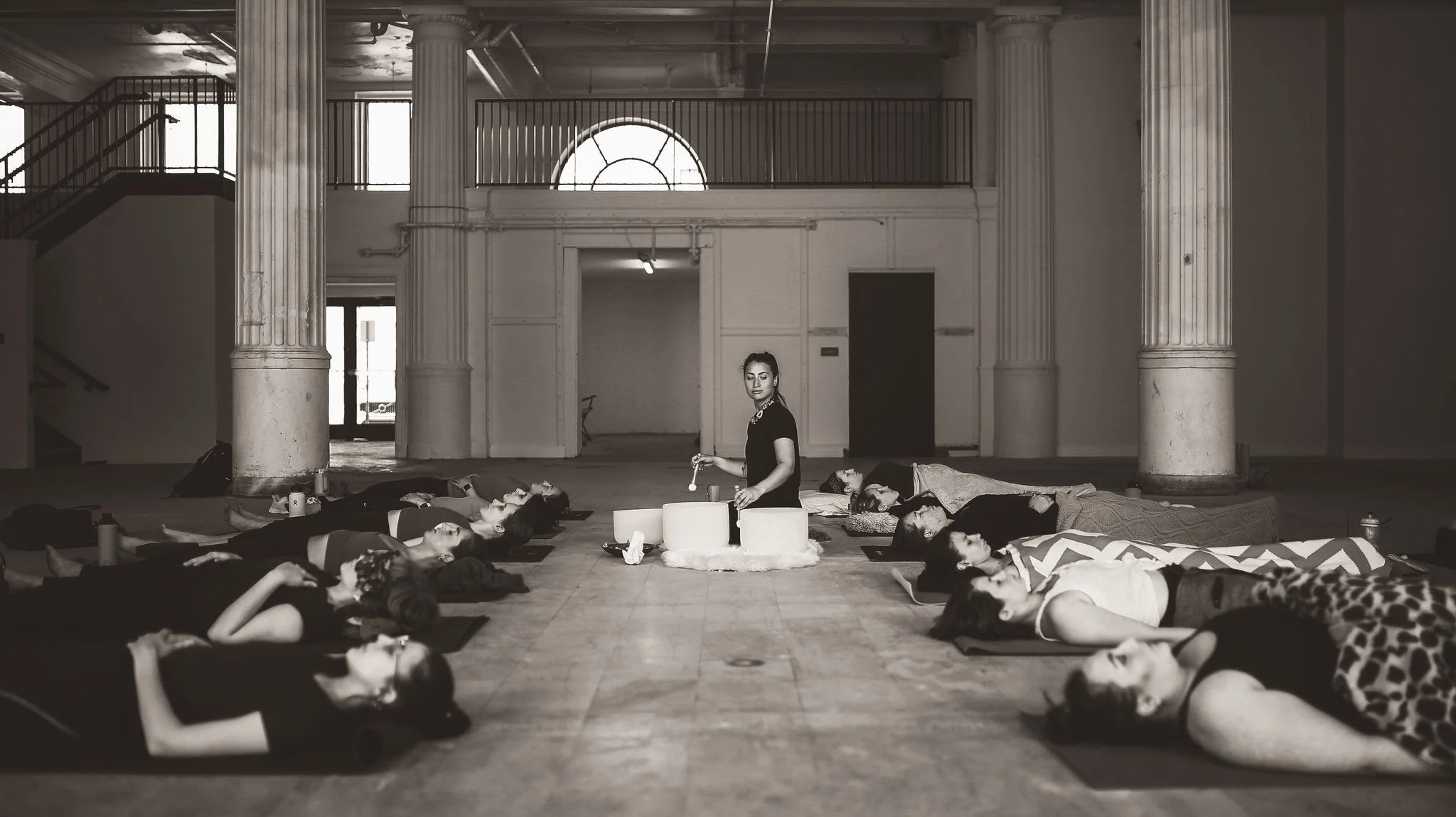 A group of people laying down during a yoga class 