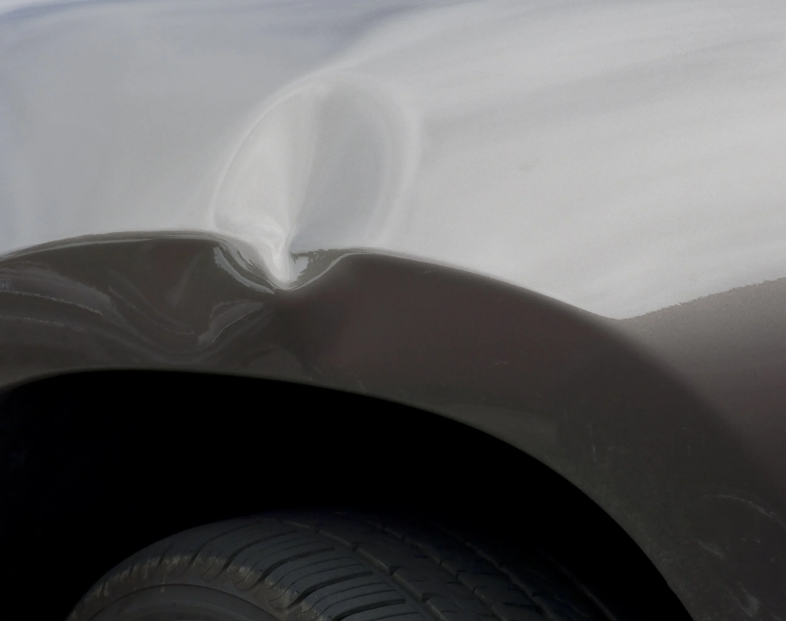 Paintless door ding repair on vehicle door by Dent Busters Auto Hail Repair