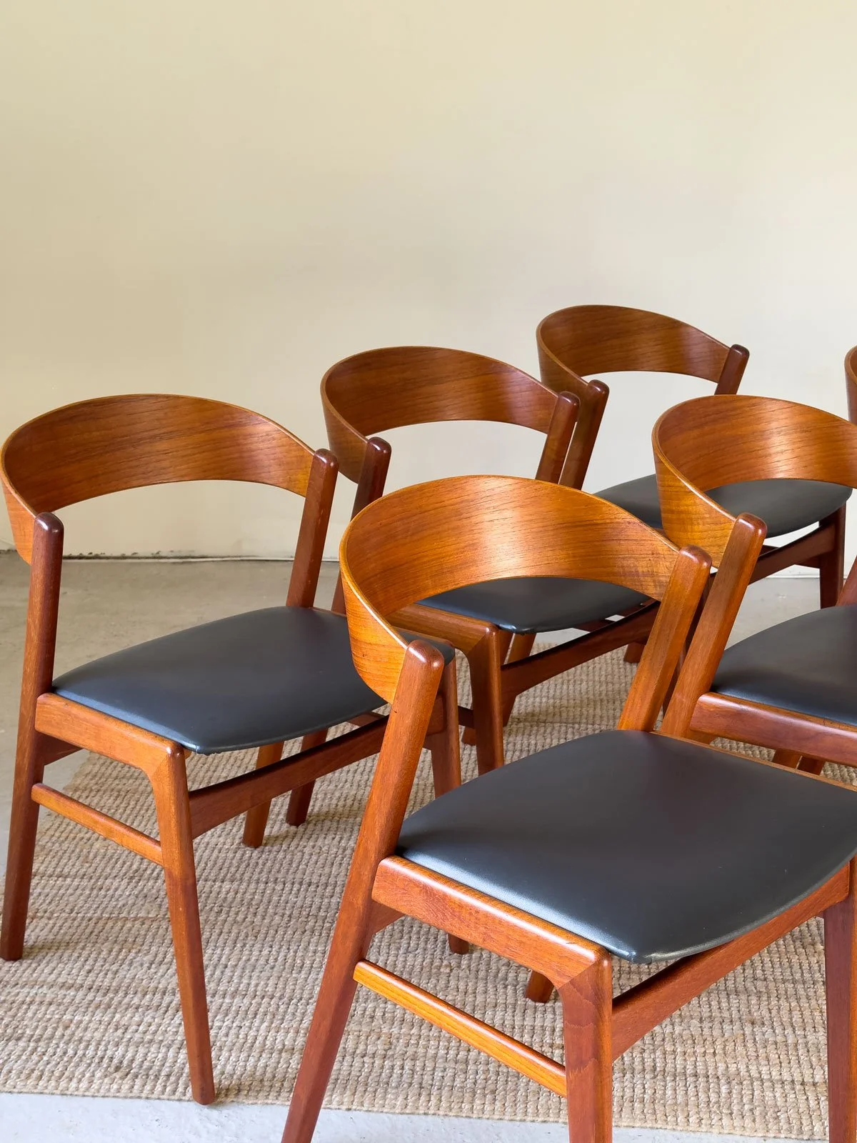 “Detail of teak frame and black vinyl seat on Erik Kirkegaard dining chair”