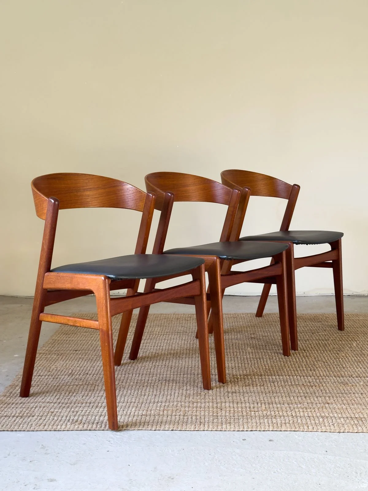 “Angled view of Erik Kirkegaard teak dining chair with newly upholstered seat”
