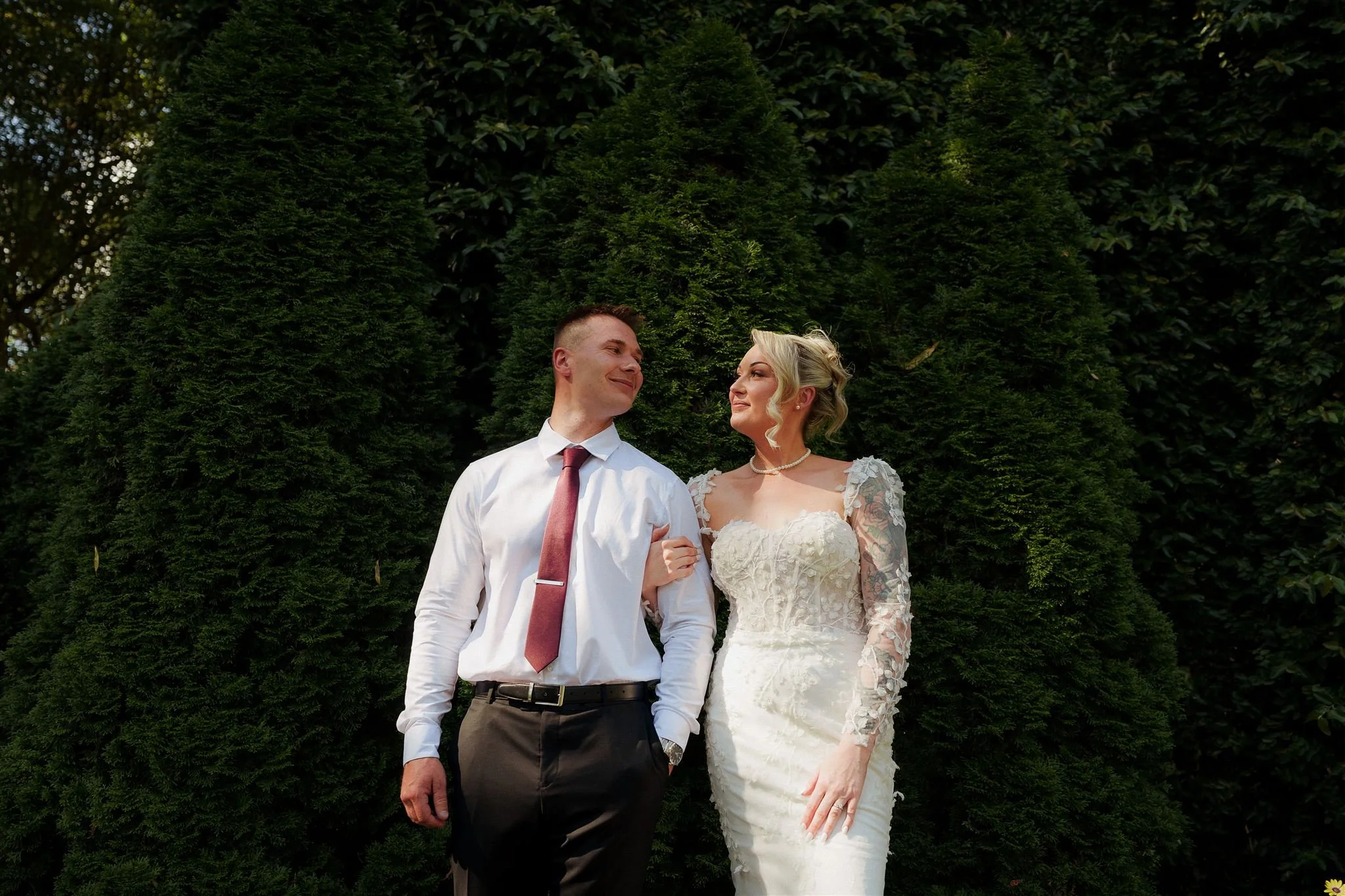 Cute image of groom with no jacket and bride in floral dress on their photo session after their ceremony