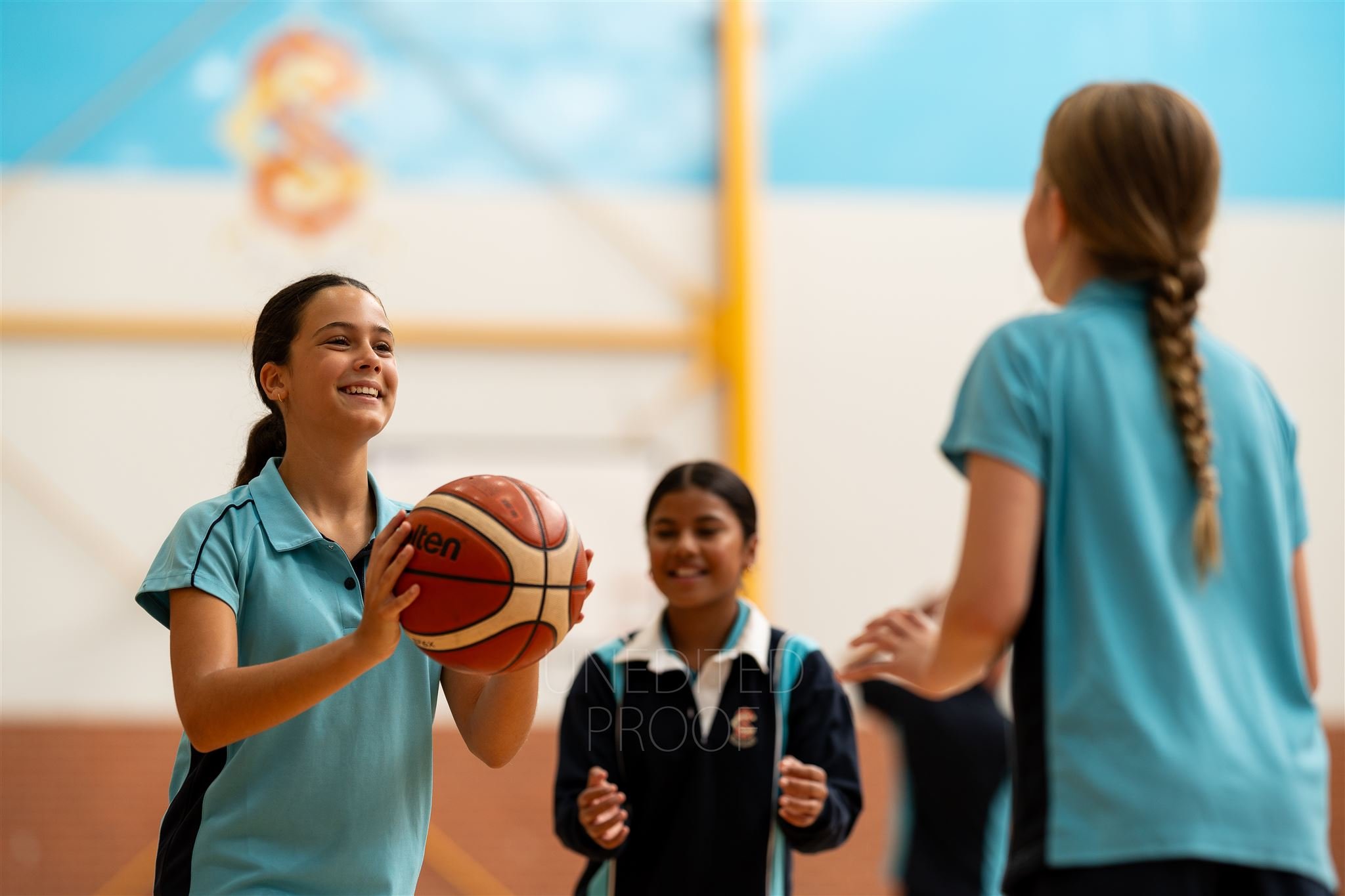 Unedited image of girls playing basketball indoors
