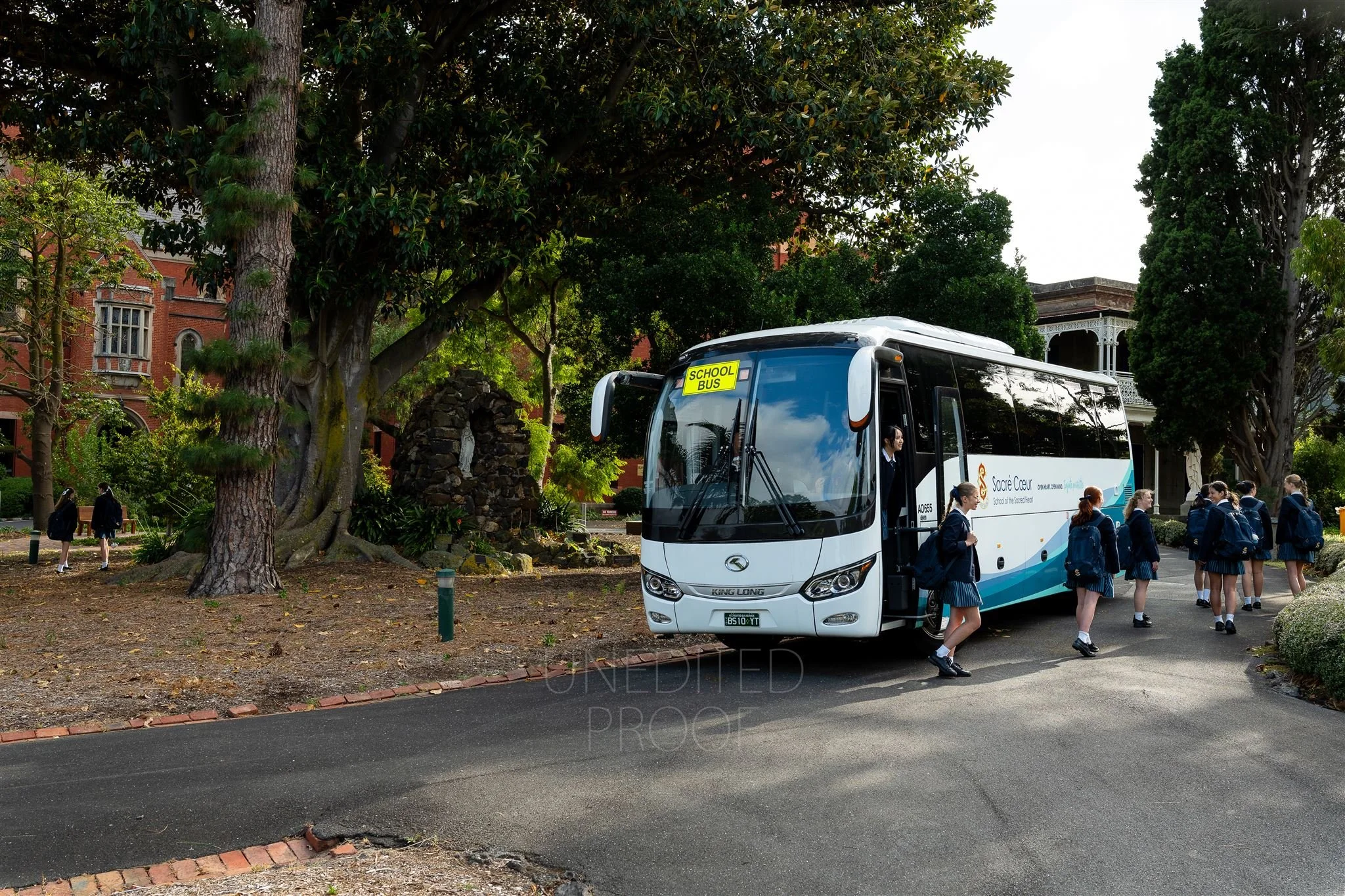 Unedited image of straight out of camera of students getting off a bus at school