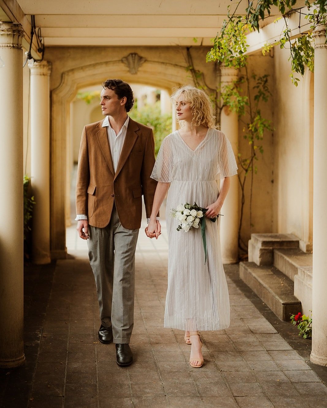 Couple dressed in similar colours for an engagement photo session at Ripponlea Estate with a very Italian vibe
