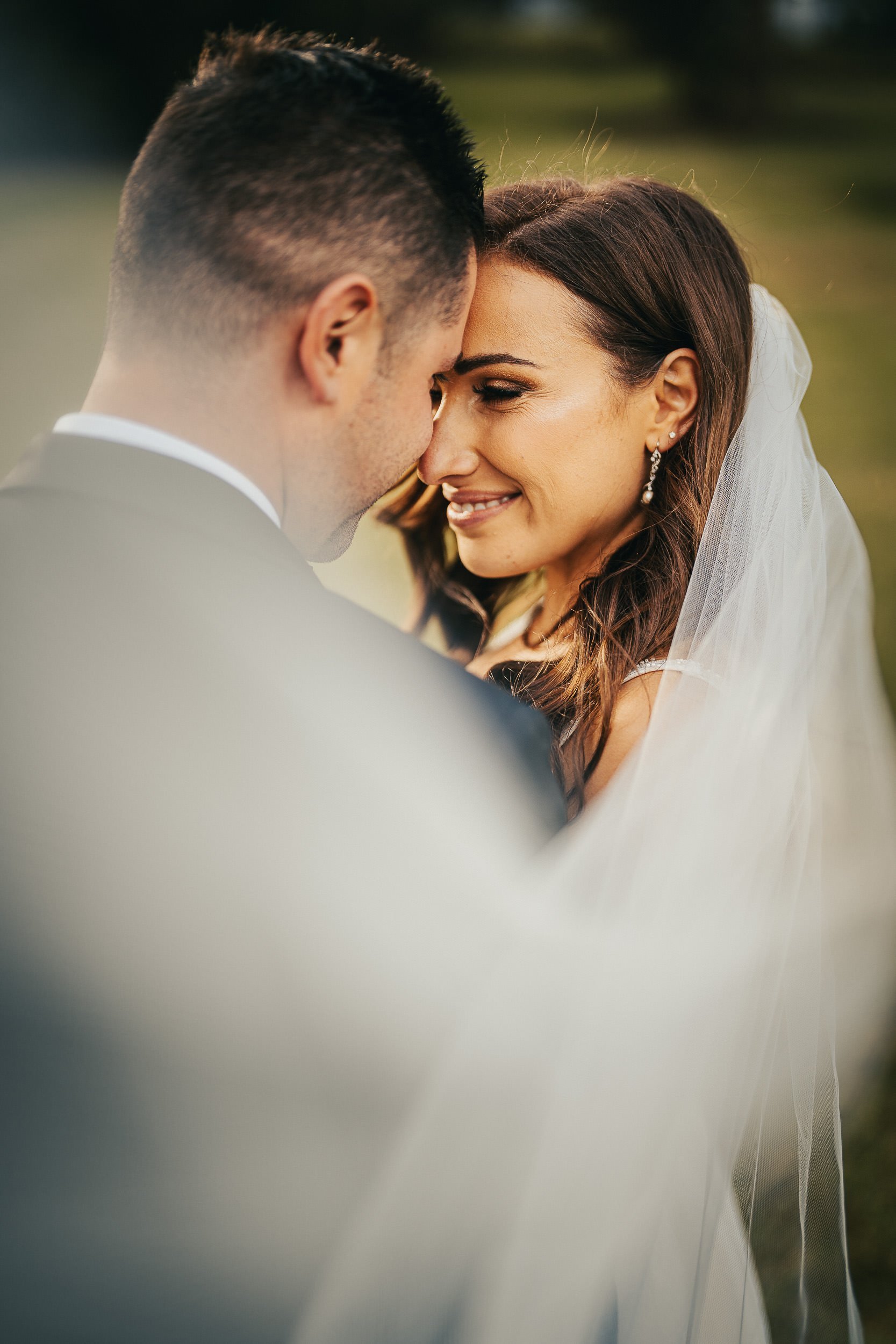 Close up or wedding couple cuddling on their wedding day