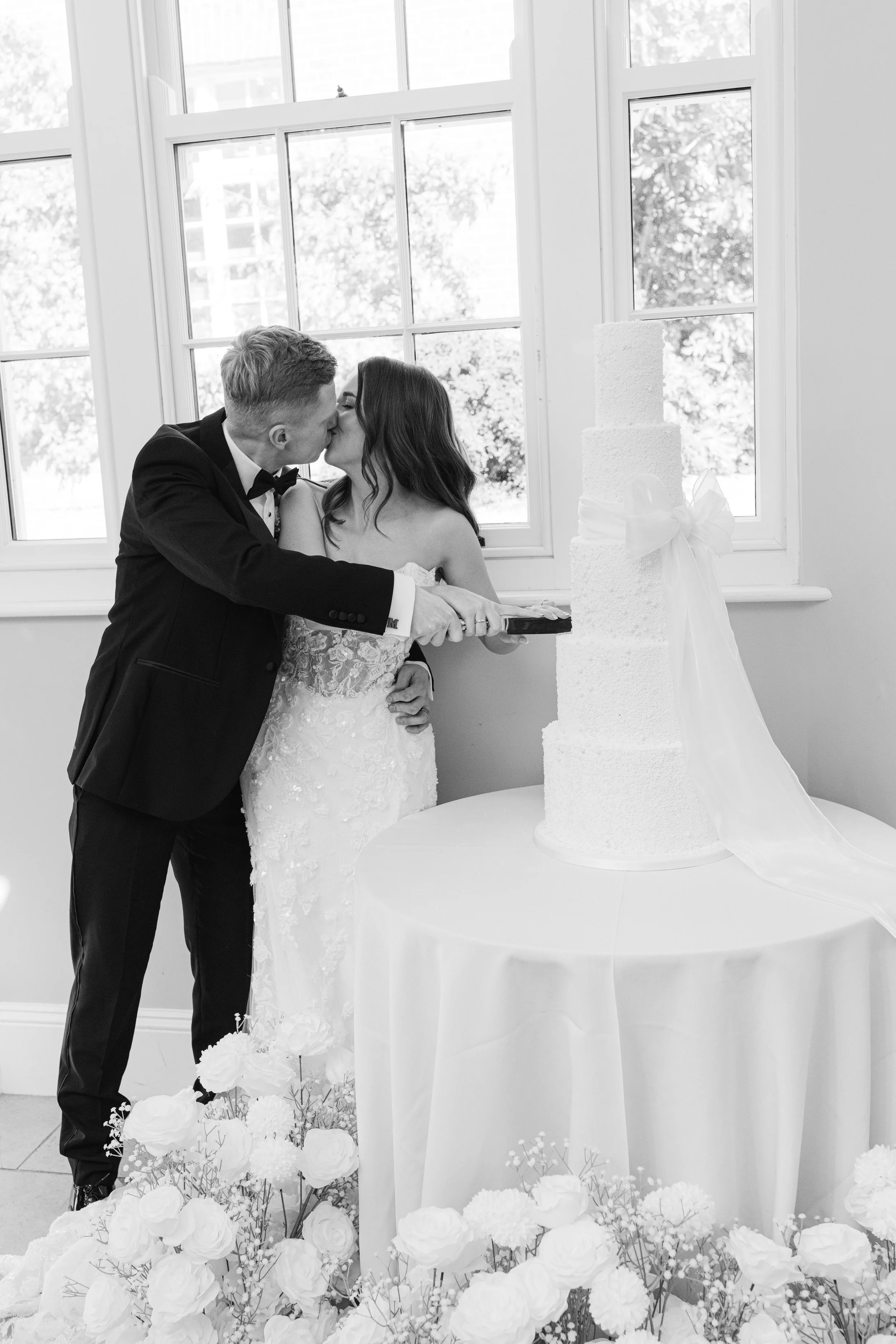 Bride and groom cutting their cake at Rockbeare Manor.