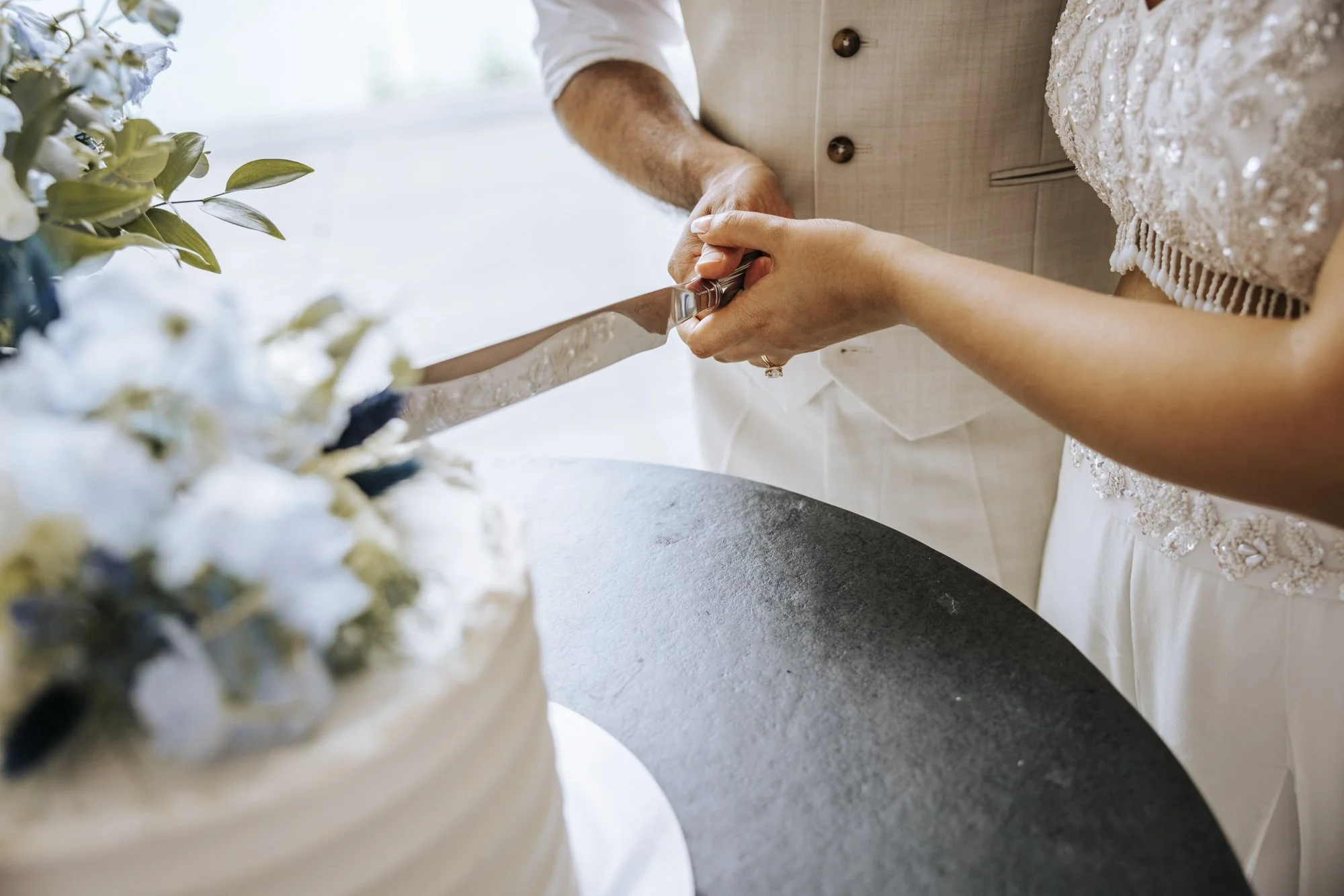Bride and groom cutting their wedding cake at Sandy Cove Hotel.