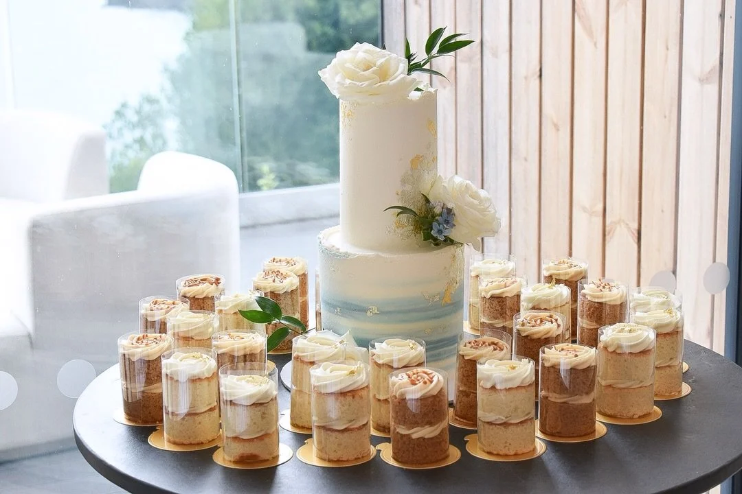 Abbey &amp; Simon knew exactly what they wanted from the moment I met them.

For their wedding at Sandy Cove, they went for a two-tier cake with edible gold, fresh florals and soft coastal tones with 30 mini cakes surrounding it.

I loved creating th