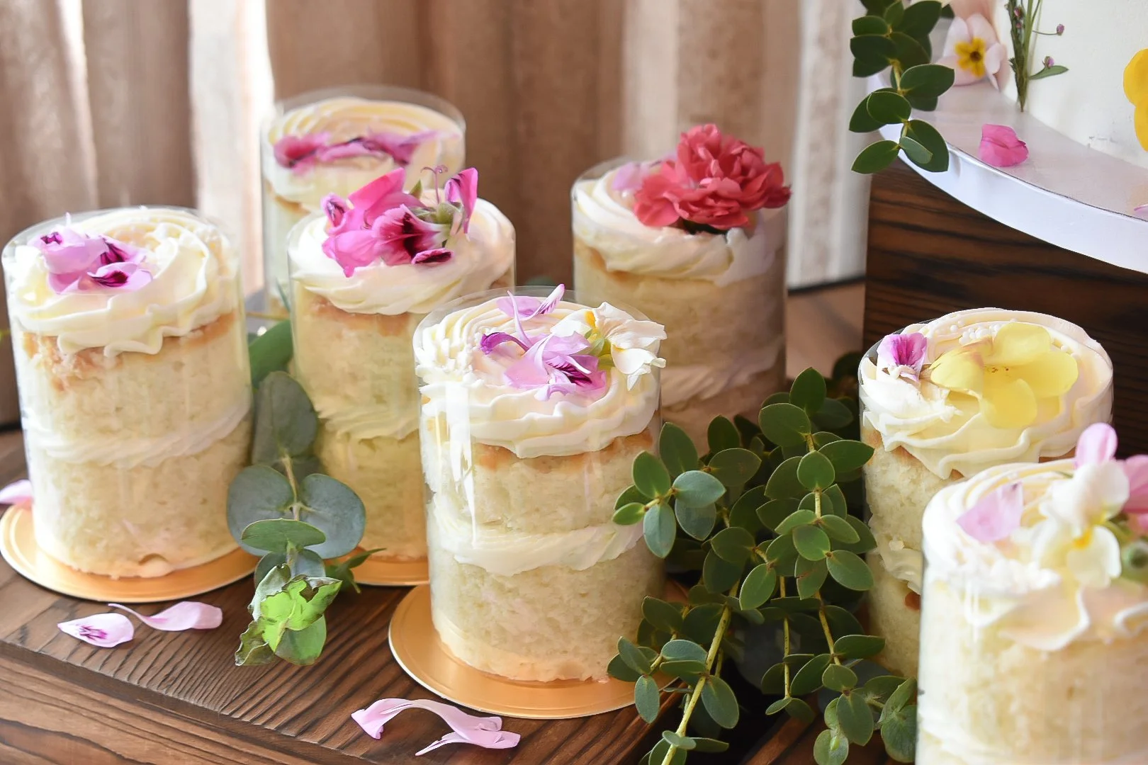 Heart-shaped cookies and layered pastries on a decorative tray with floral background.