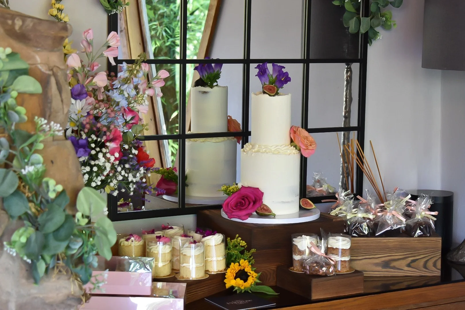 Wedding dessert table with two-tier buttercream cake. 