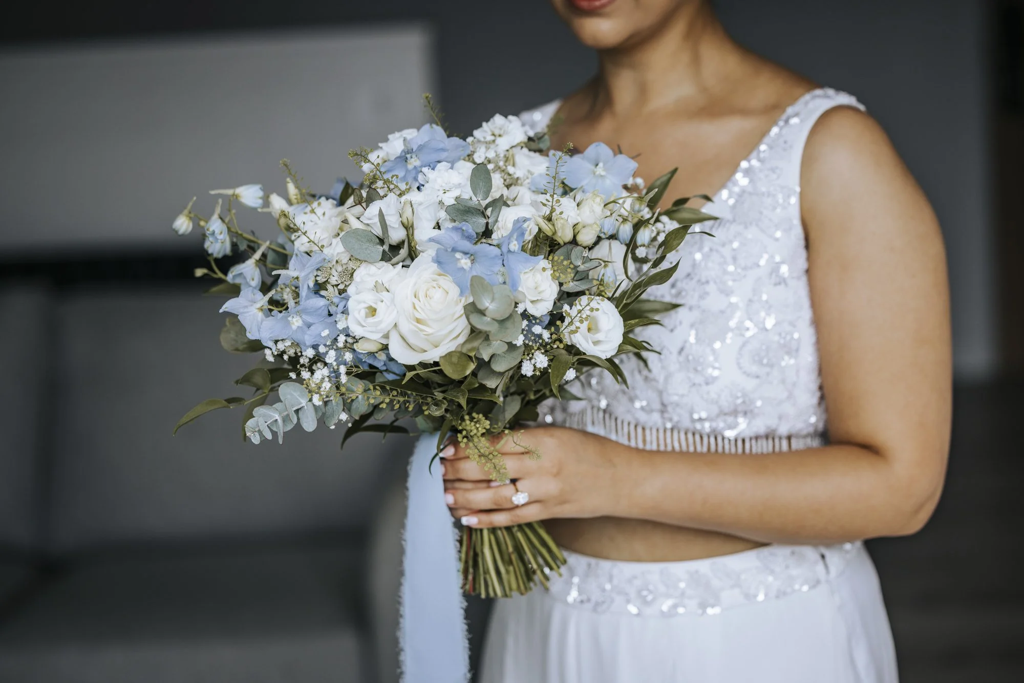 Bride at Sandy Cove Hotel with ivory and blue bouquet
