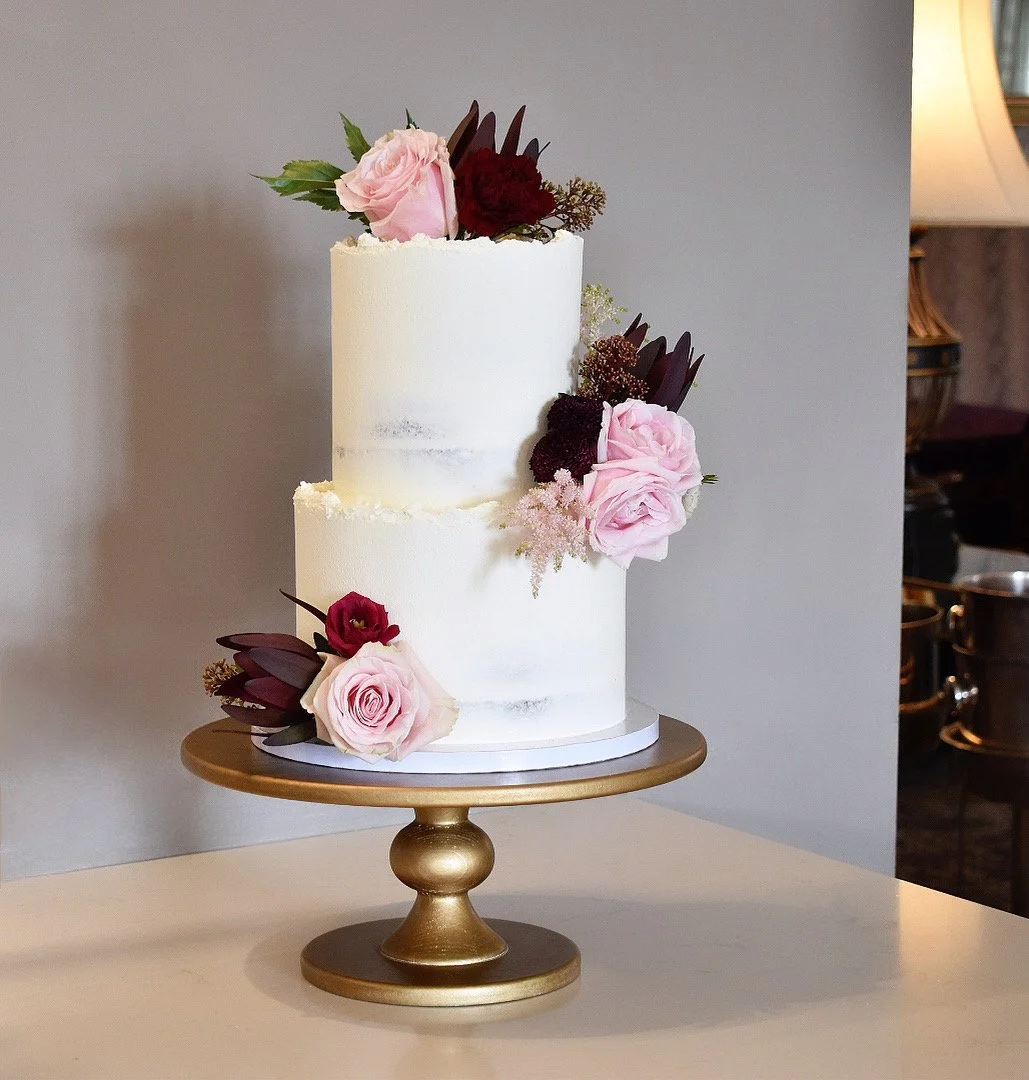 Semi-Naked Wedding Cake with fresh flowers at Bovey Castle, Devon.