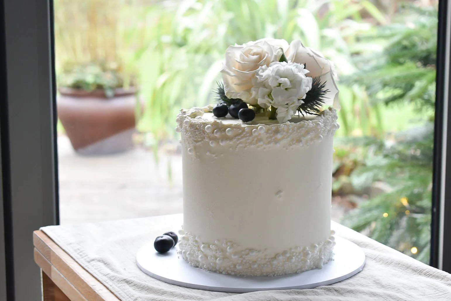 White buttercream elopement wedding cake with pearl detail in Devon.