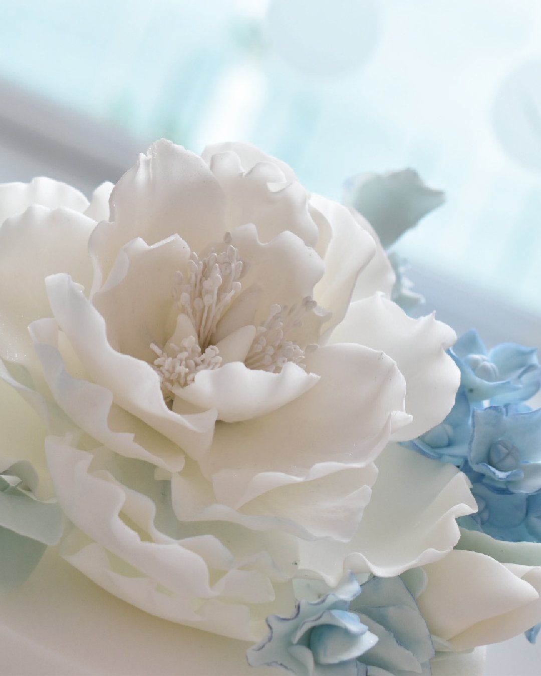 Handmade sugar flowers on a wedding cake.