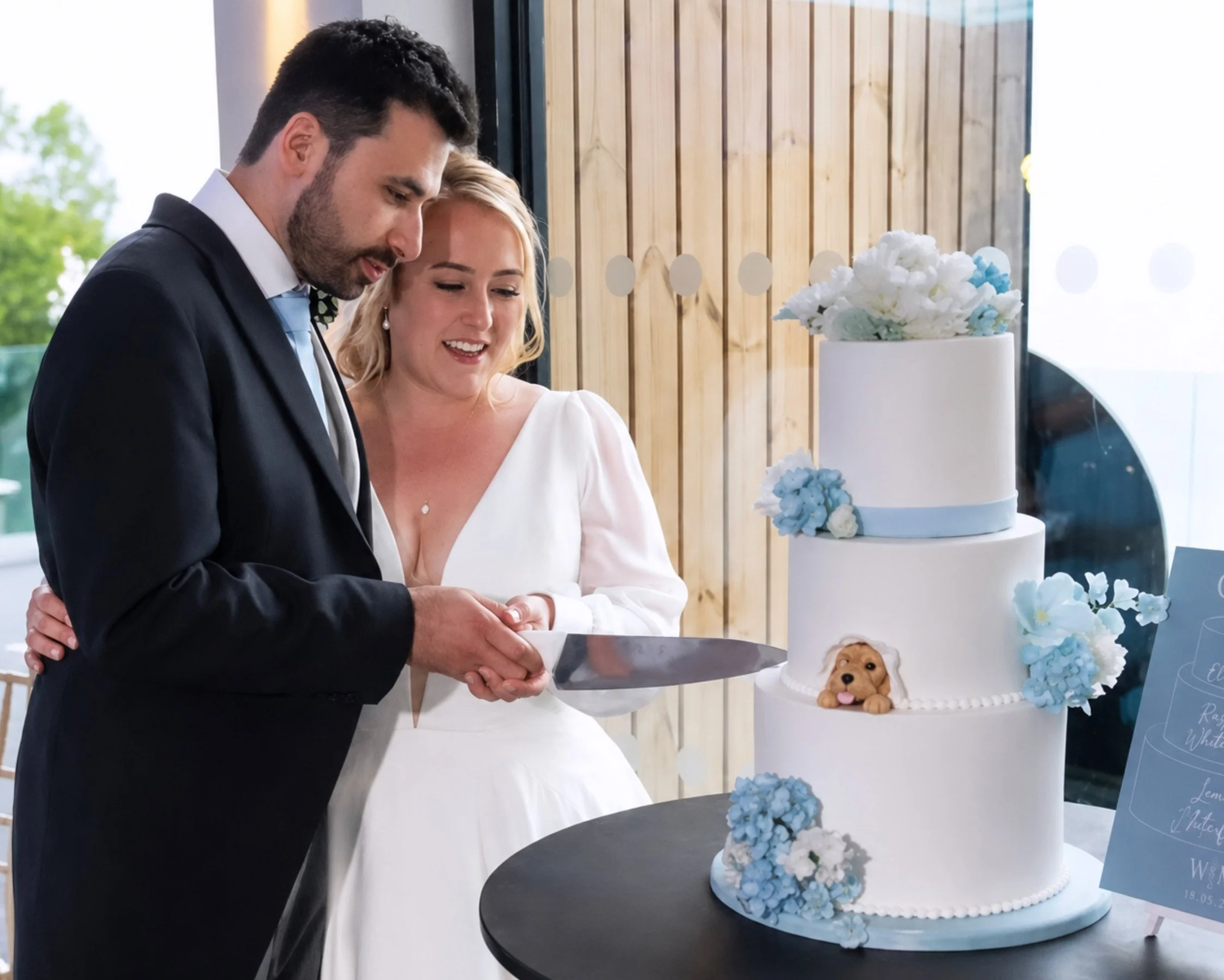 Bride and groom cutting their wedding cake at Sandy Cove Hotel.