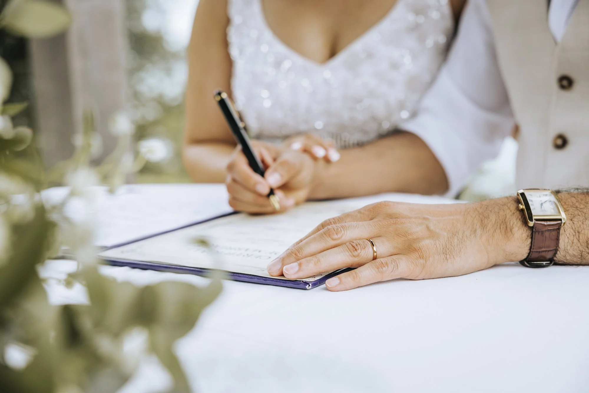 Bride and groom signing the wedding register at Sandy Cove Hotel