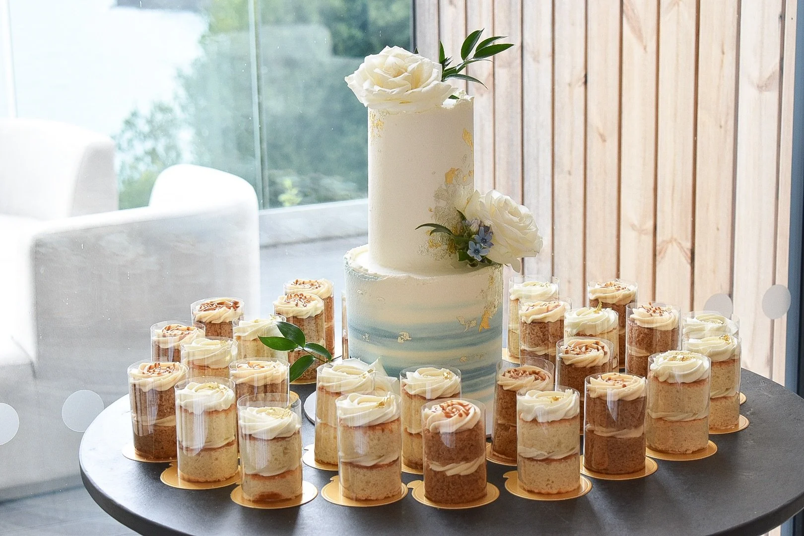 Buttercream wedding cake and mini-cakes at Sandy Cove, Devon.