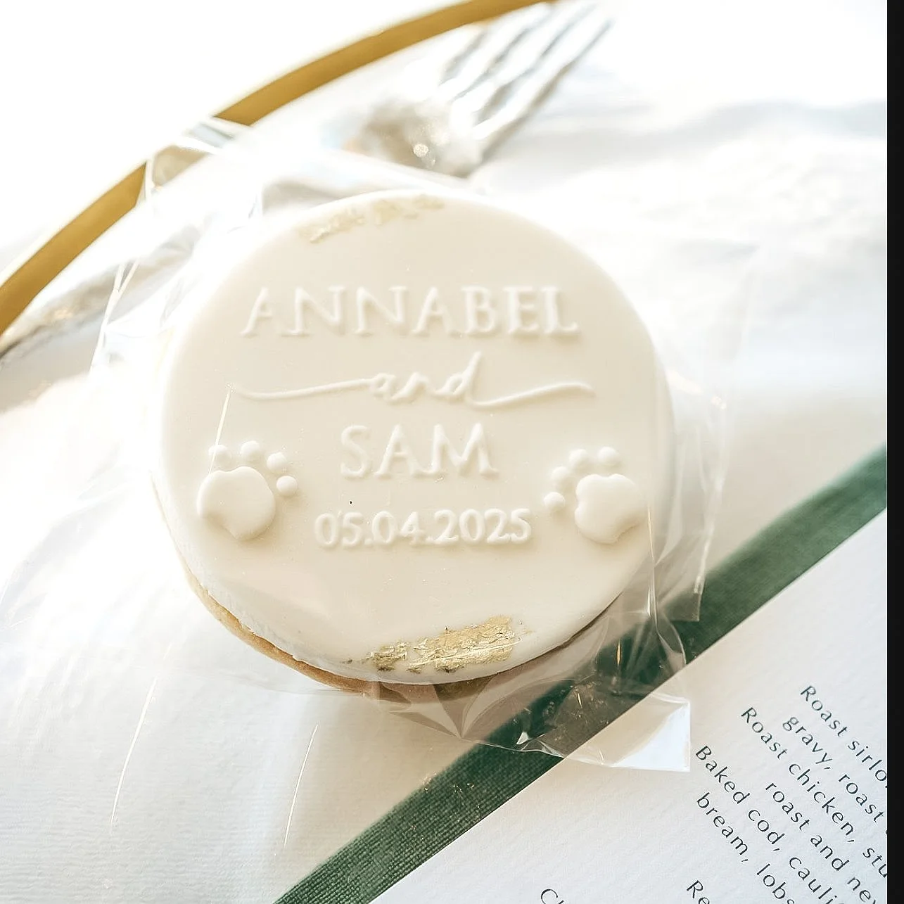 Bespoke wedding favour biscuit with edible gold leaf.