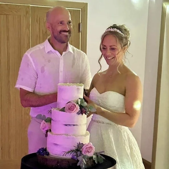 Bride and Groom cutting luxury wedding cake in Devon
