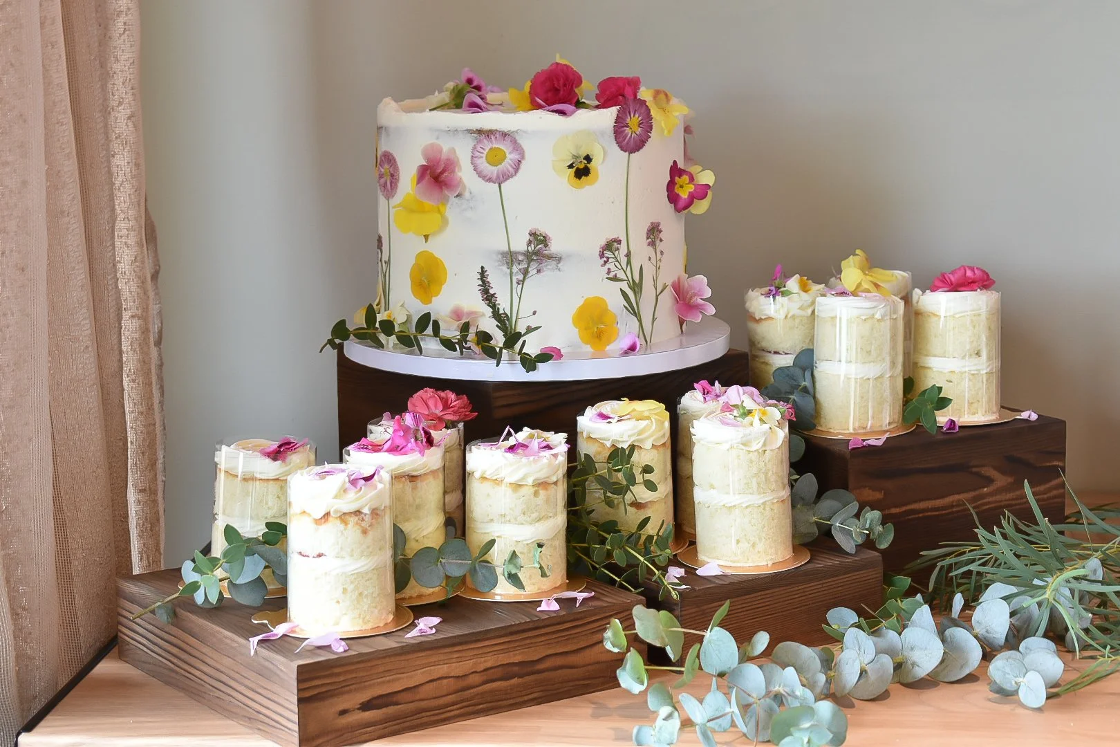 pressed and fresh edible flower elopement cake with mini-cakes.