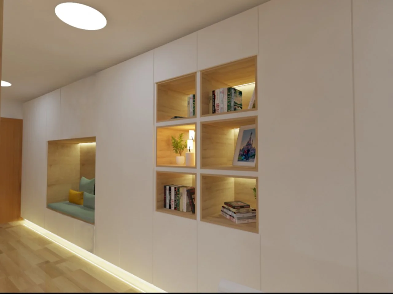 parede branca com nichos de madeira iluminados, decorados com livros, um quadro, uma planta, e uma área de assento com almofadas ao lado.