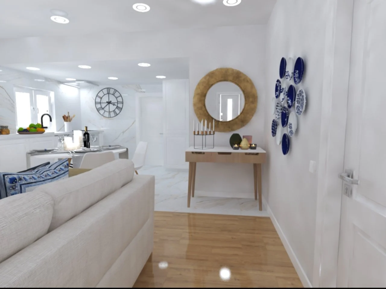 Home Staging de Moradia, Torres Vedras.
Perspetiva de Sala de estar e cozinha integradas, com paredes brancas, piso de madeira e decoração com espelhos, de pratos azuis, relógio na parede, sofá bege, mesa de jantar branca, velas e objetos decorativos