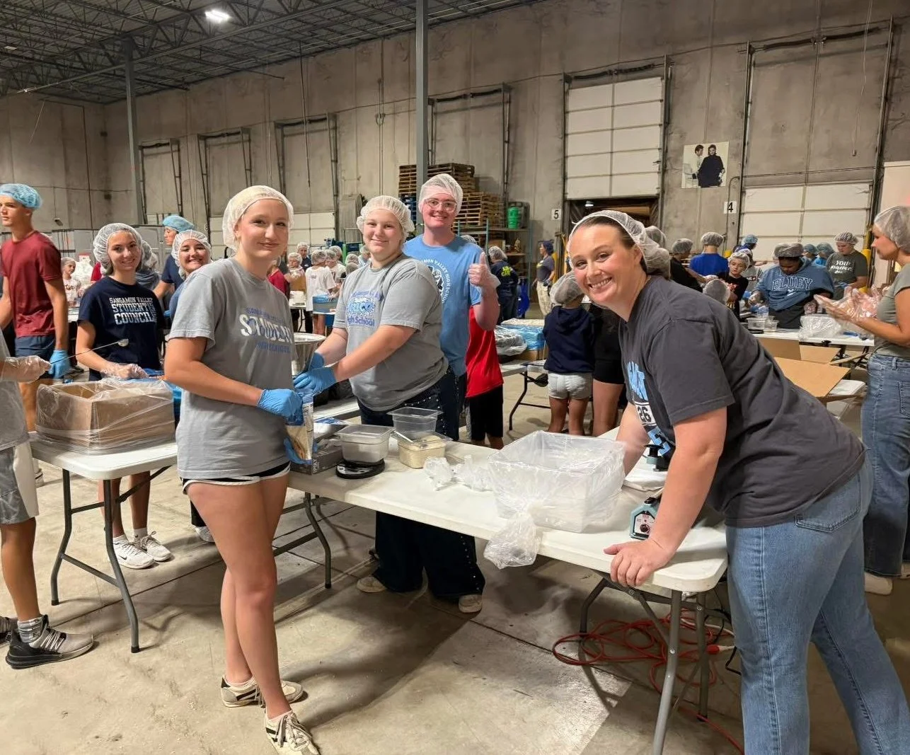 SV students in NHS prepare meals for "Feed My Starving Children" on a service trip.