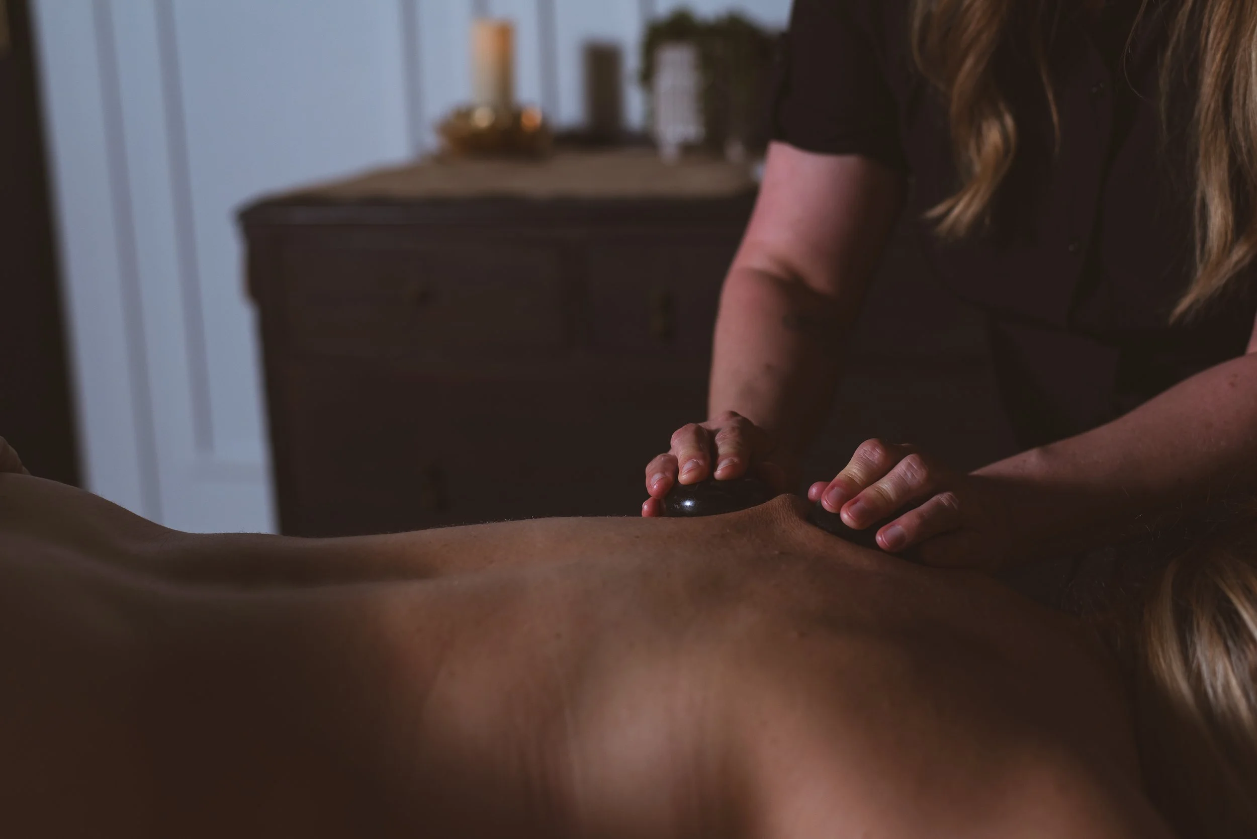 Massage therapist branding photo - close up of a hot stone massage