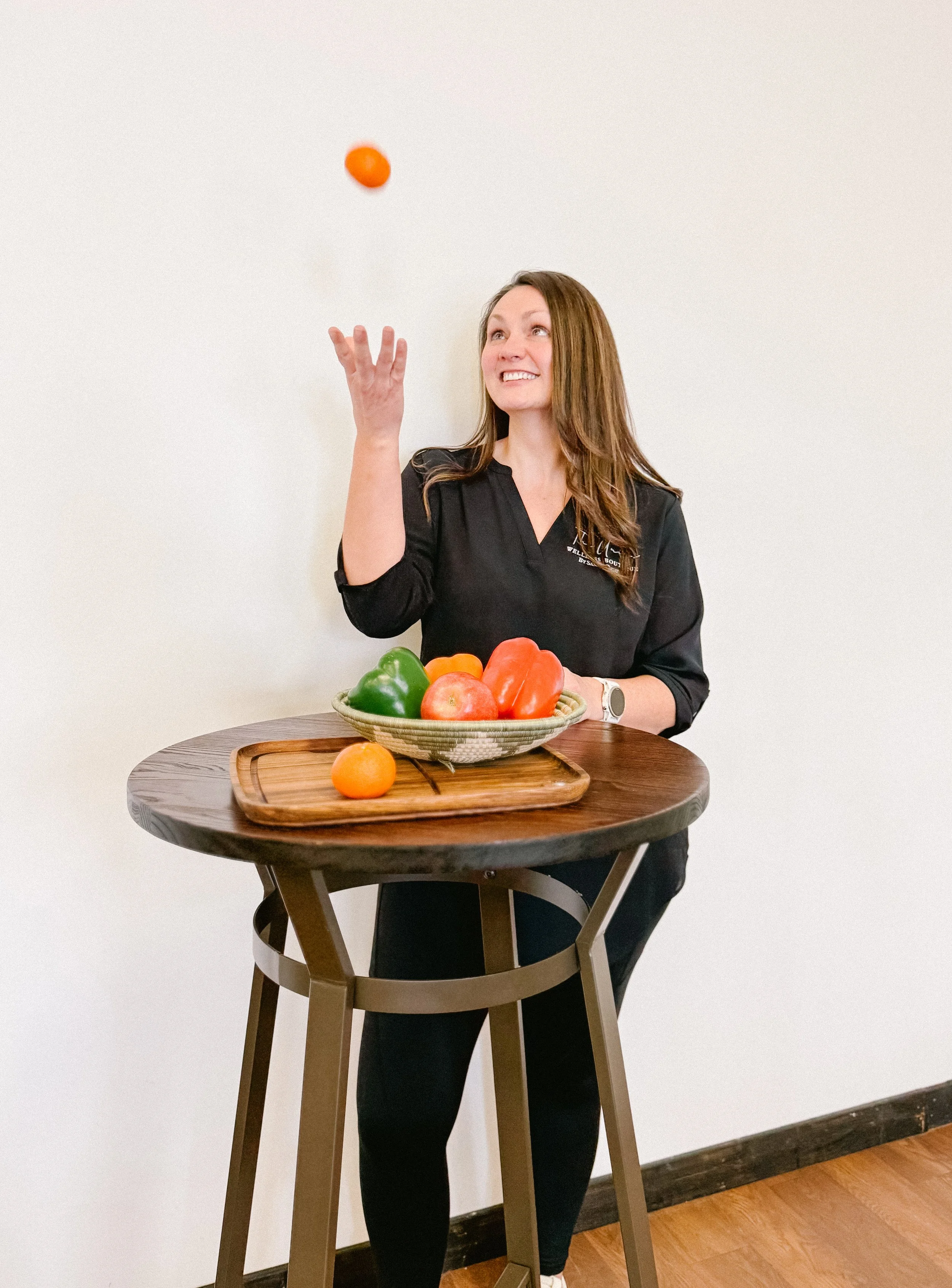 Health Coach, Nicole, with fruits and vegetables for healthy eating