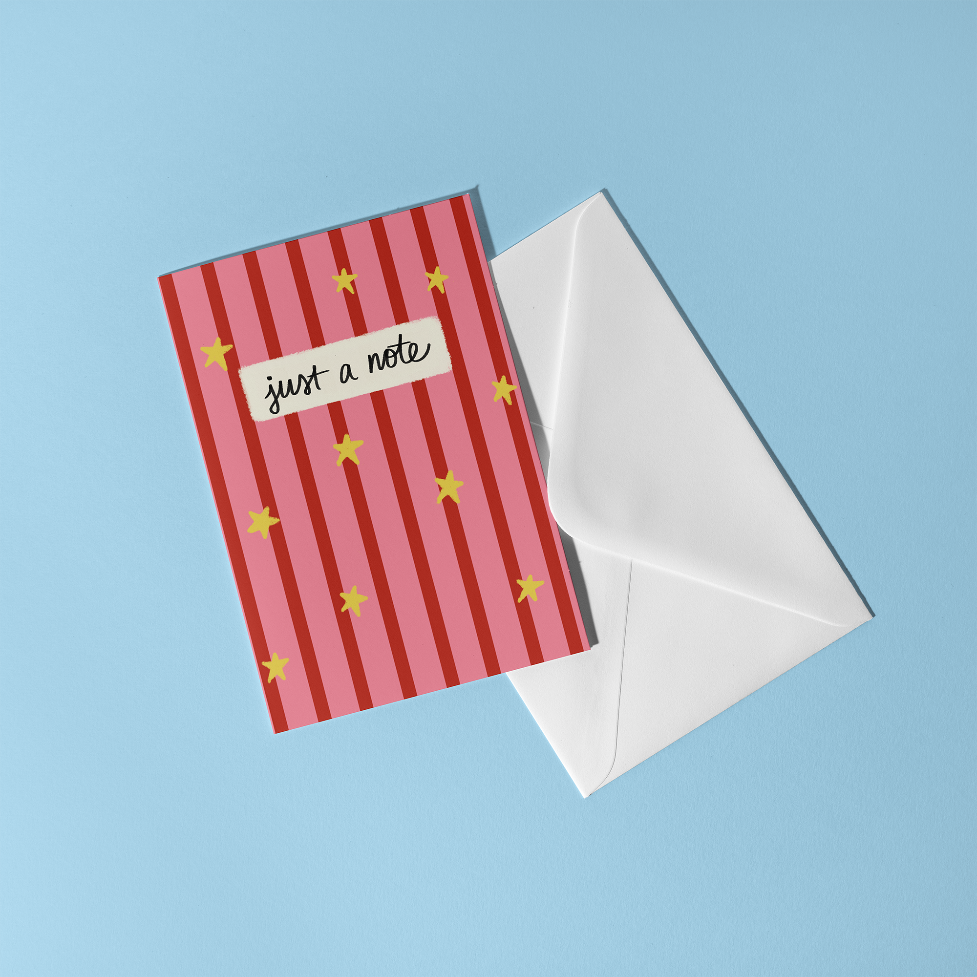 Pink and red striped greeting card with yellow stars, reading "Just a note"