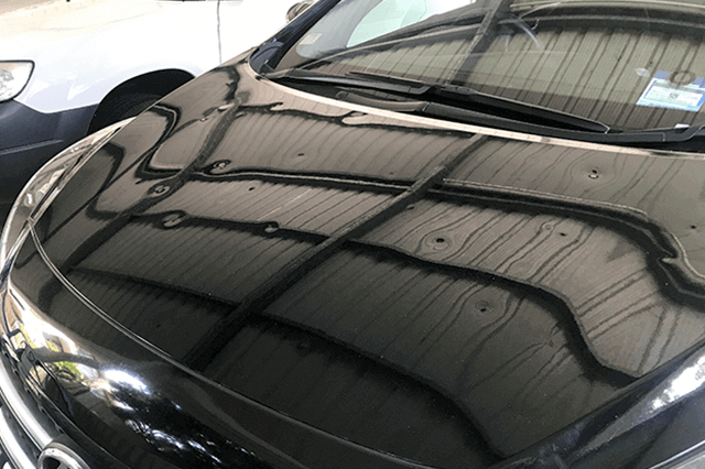 Car hood with roof reflection and possible hail damage dents. Hail Damage, Who repairs hail in NZ, NZ Hail Repairs, Platinum Hail Managment, Hail Associates, Hail damaged cars.
