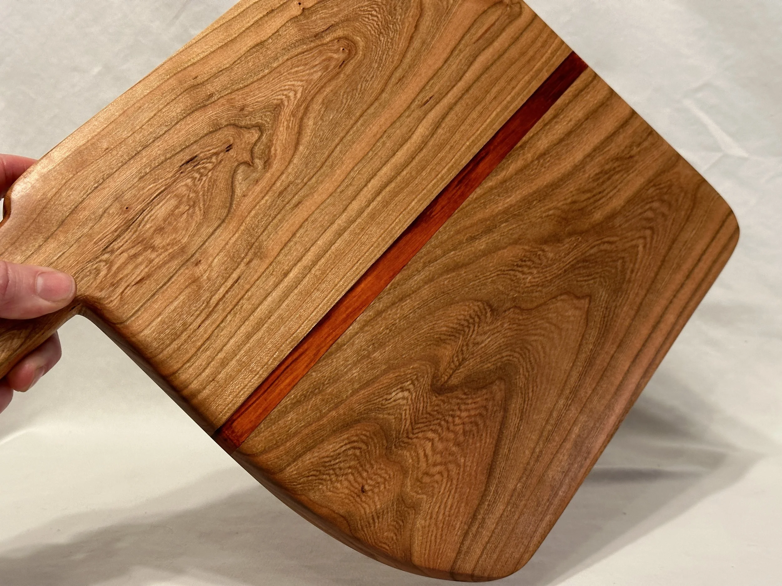 Macellaro Made Charcuterie Board - Cherry and Paudek woods. Nice handle that fits your hand, makes it easy to carry the tray loaded with your favorite cheeses, meats, and crackers - ST00001