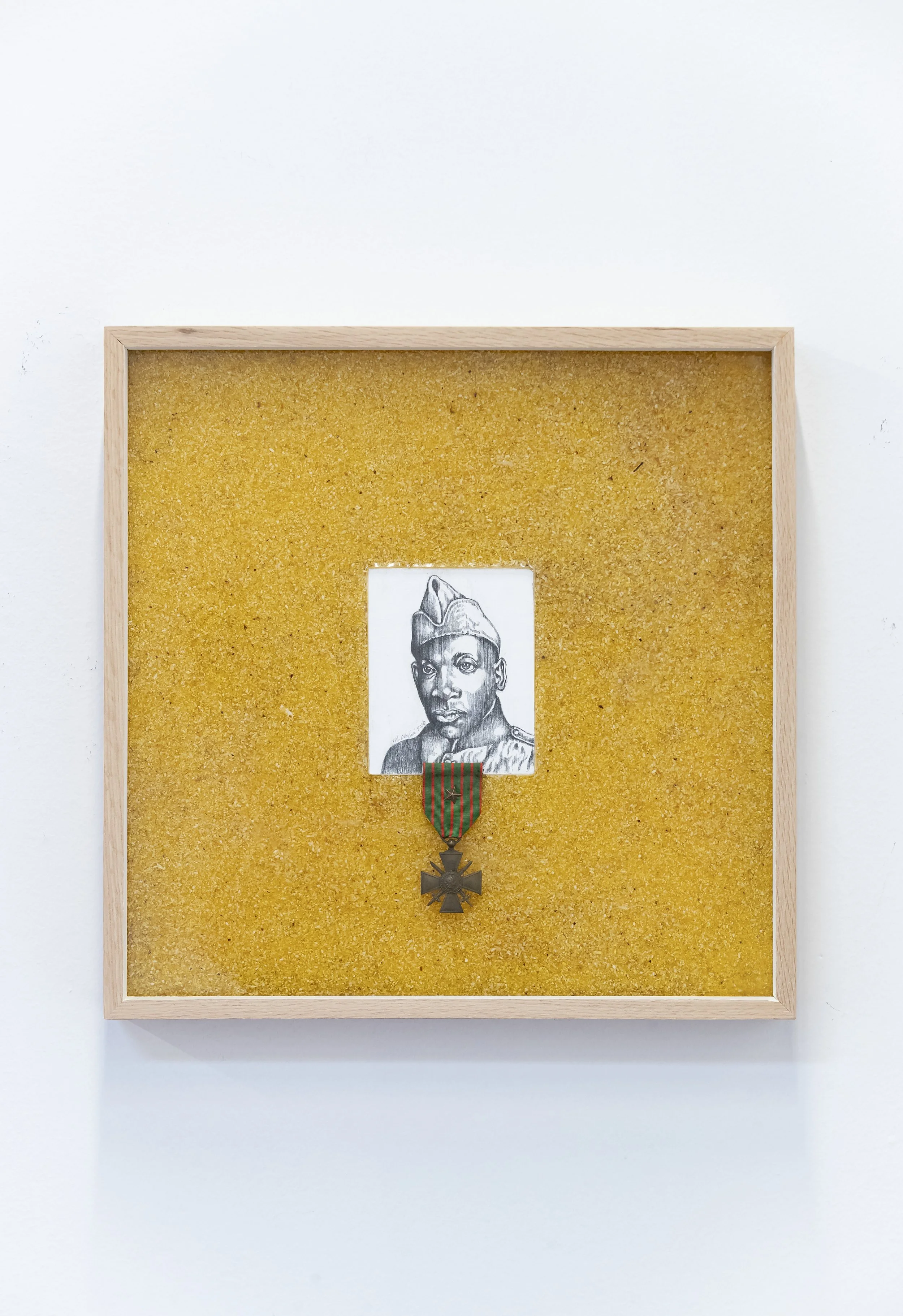 Food Notes #2: Grit for Henry L. Johnson,
2026.
16 ¾” x 16 ¾” x 2.5”
Graphite on wood panel, resin, French medal, and grits.
Description: Henry L. Johnson born in Winston-Salem, NC, was a WW1 US soldier, who fought off a German raid party in hand-to-