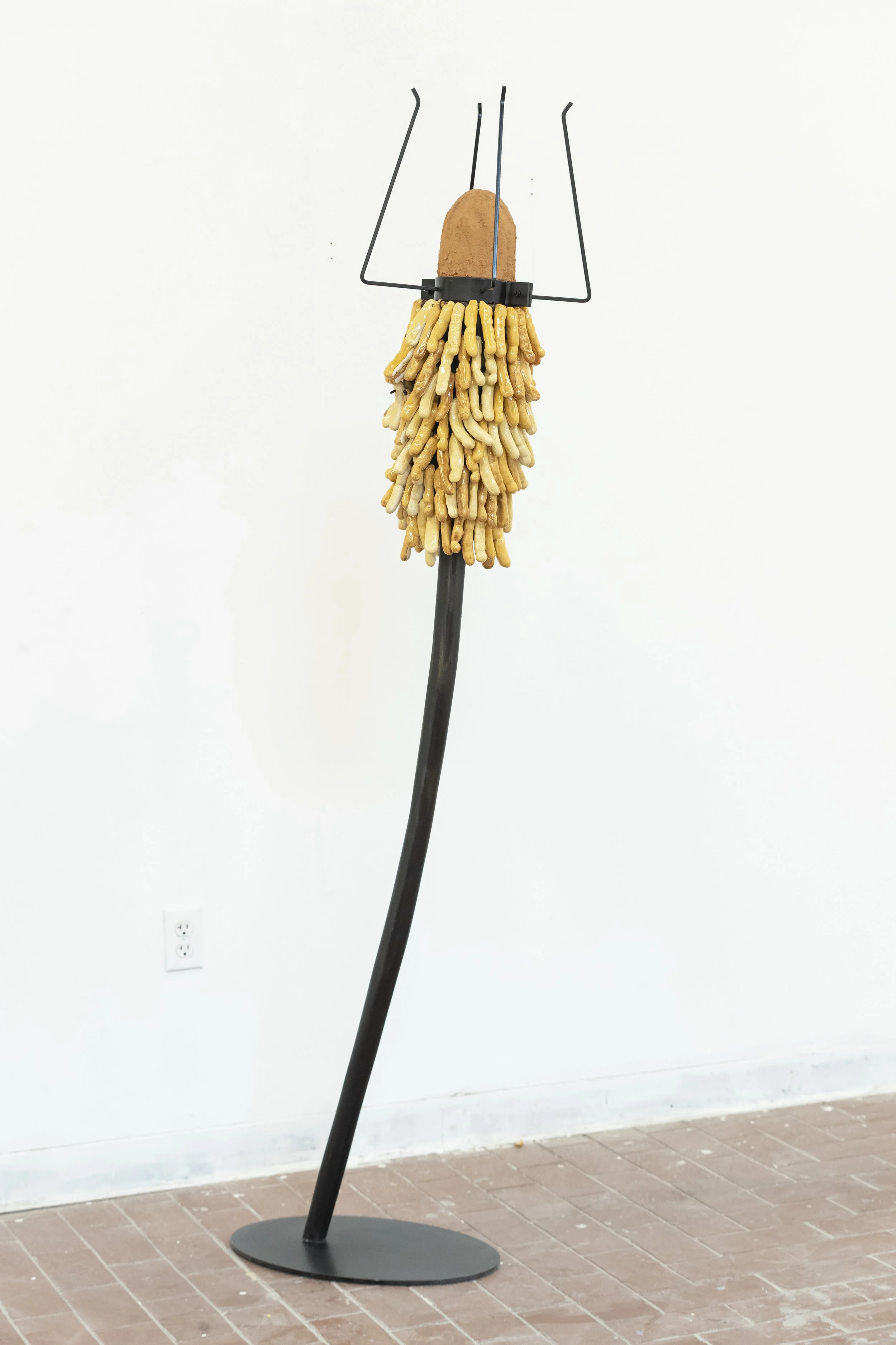 Sceptar for the Tamarind King 
2026
20” x 78”
Stoneware, steel, carved wood, red clay. 
Description: among various communities in West Africa, the tamarind tree is regarded as a sacred “spirit tree” whose deep roots reach down to the underworld, link