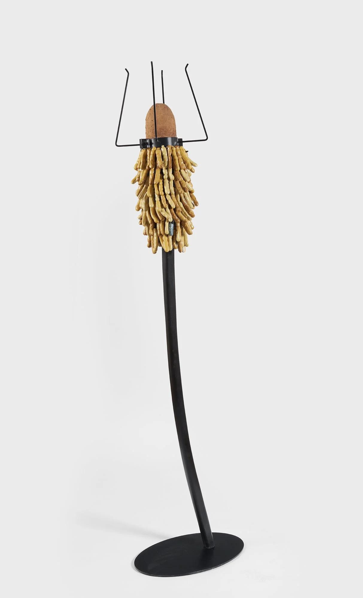 Sceptar for the Tamarind King;
2026.
20” x 78”
Stoneware, steel, carved wood, red clay. 
Description: among various communities in West Africa, the tamarind tree is regarded as  sacred.  Its deep roots reach down to the underworld, linking the ancest
