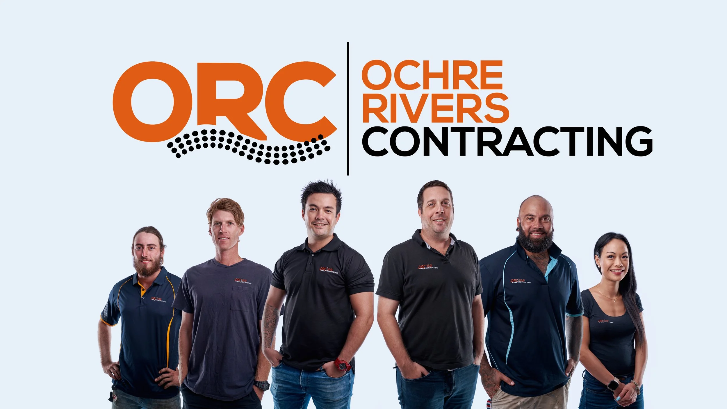 A group of six diverse individuals standing in a line in front of a light blue background with the OCR Oceans Rivers Contracting logo and text. They are smiling and wearing casual or company-branded clothing.