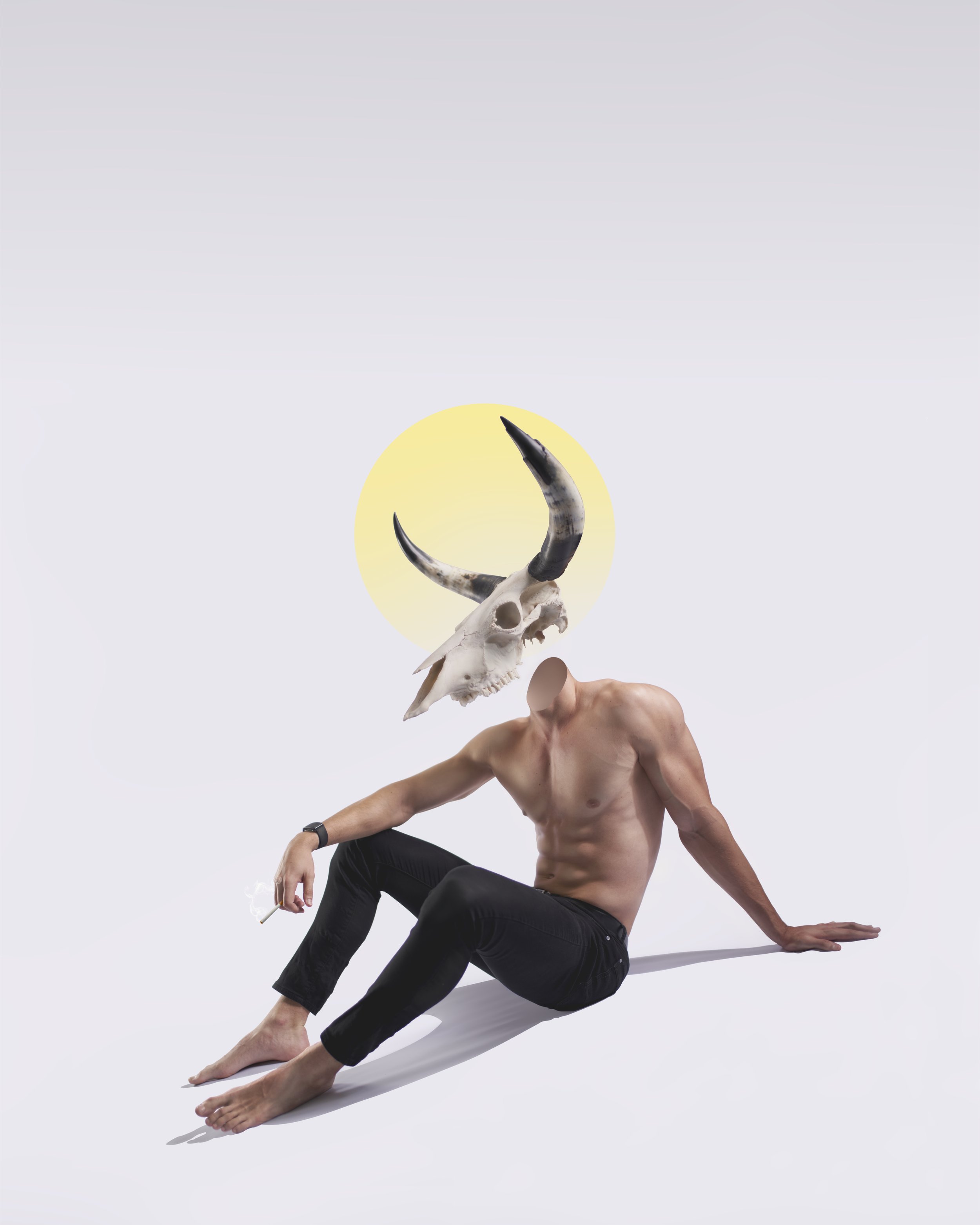 A shirtless man sitting on the ground with a skull of an animal with horns as his head, and a yellow circle resembling the moon in the background.
