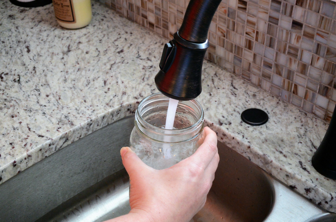 filling vase with fresh water for flowers
