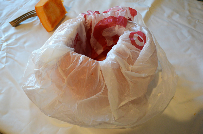lining pumpkin with a grocery bag