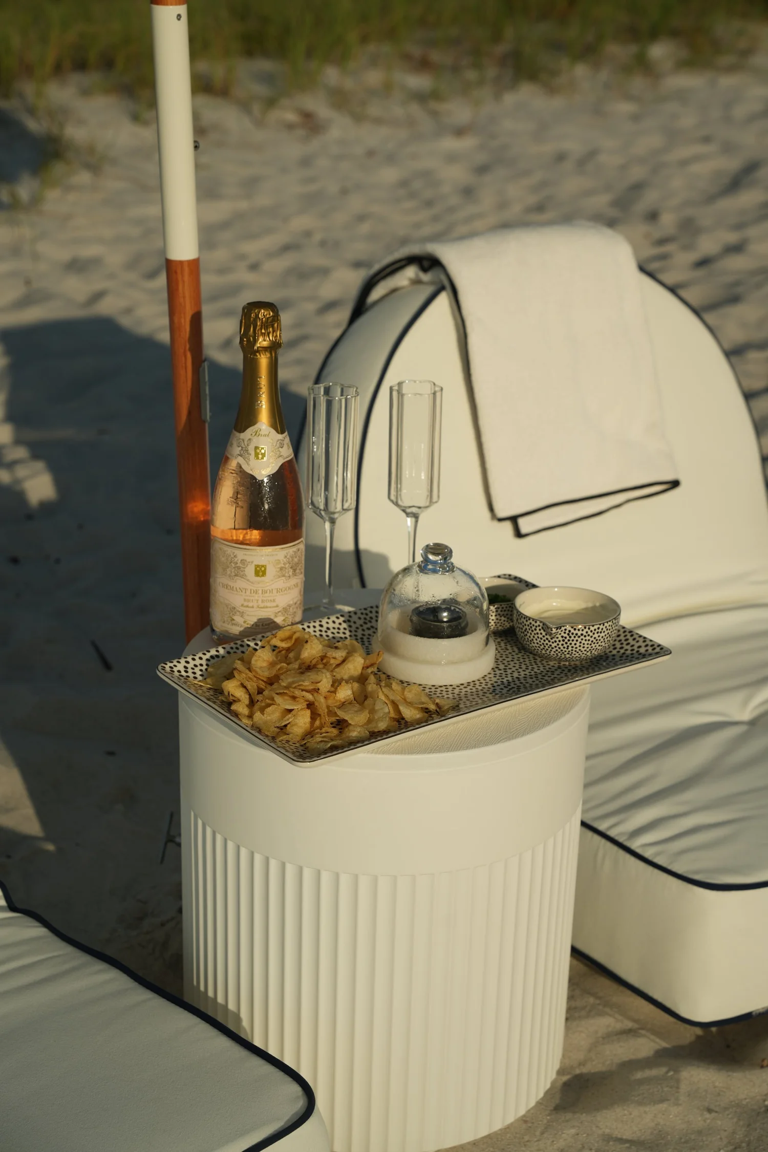 Champagne and snacks styled on a Make My Beach Day setup