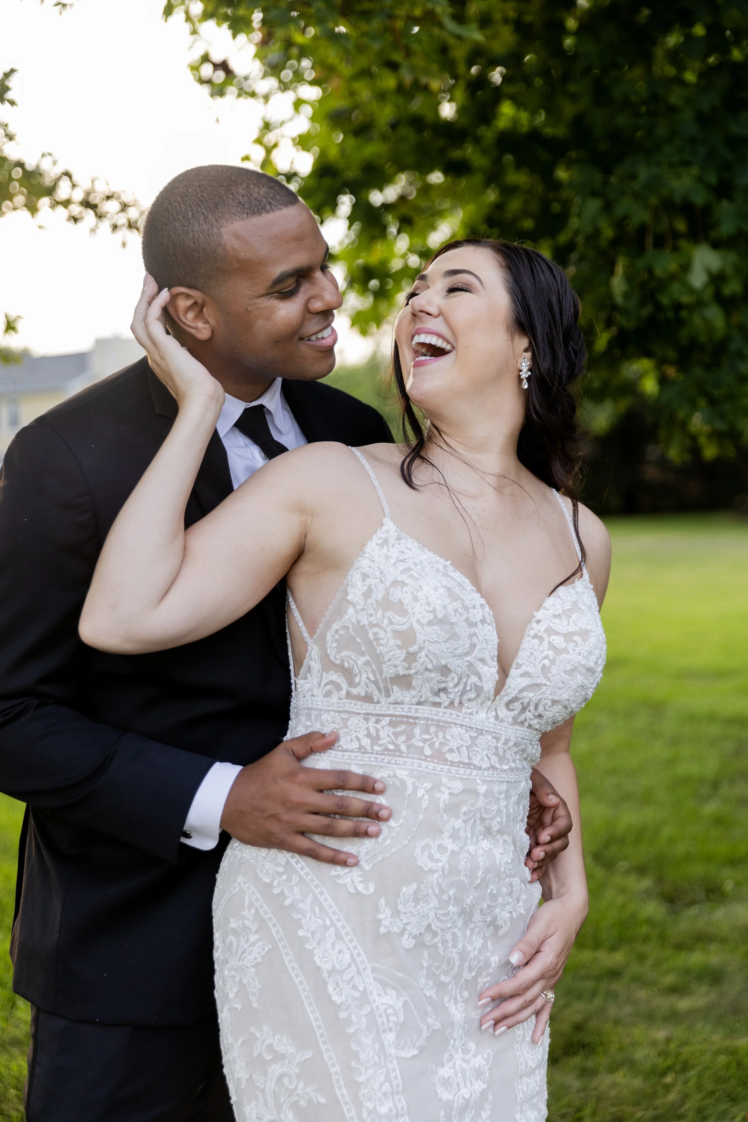 Bride and groom smiling at wedding reception at private estate